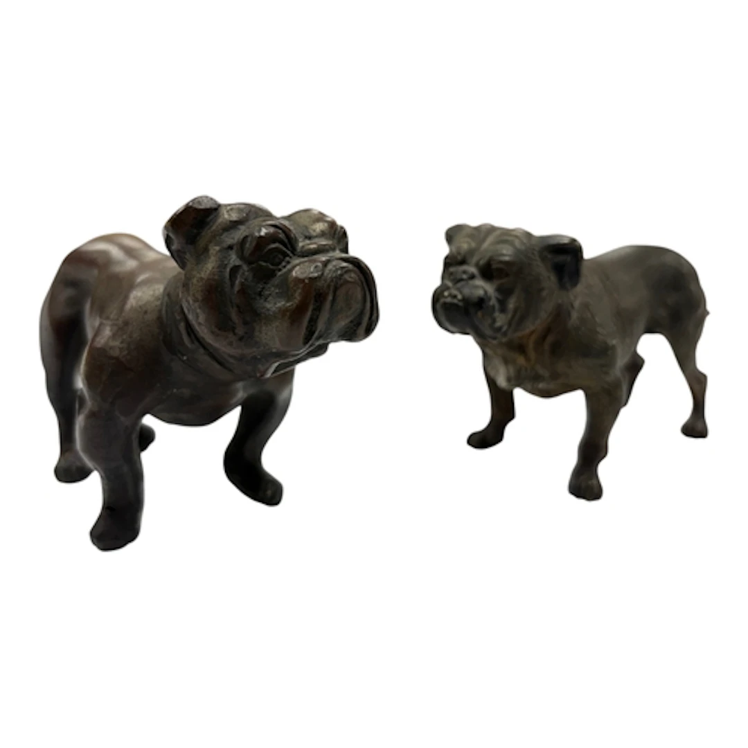 Two Austrian style bronze bulldogs, one with partial cold pa...
