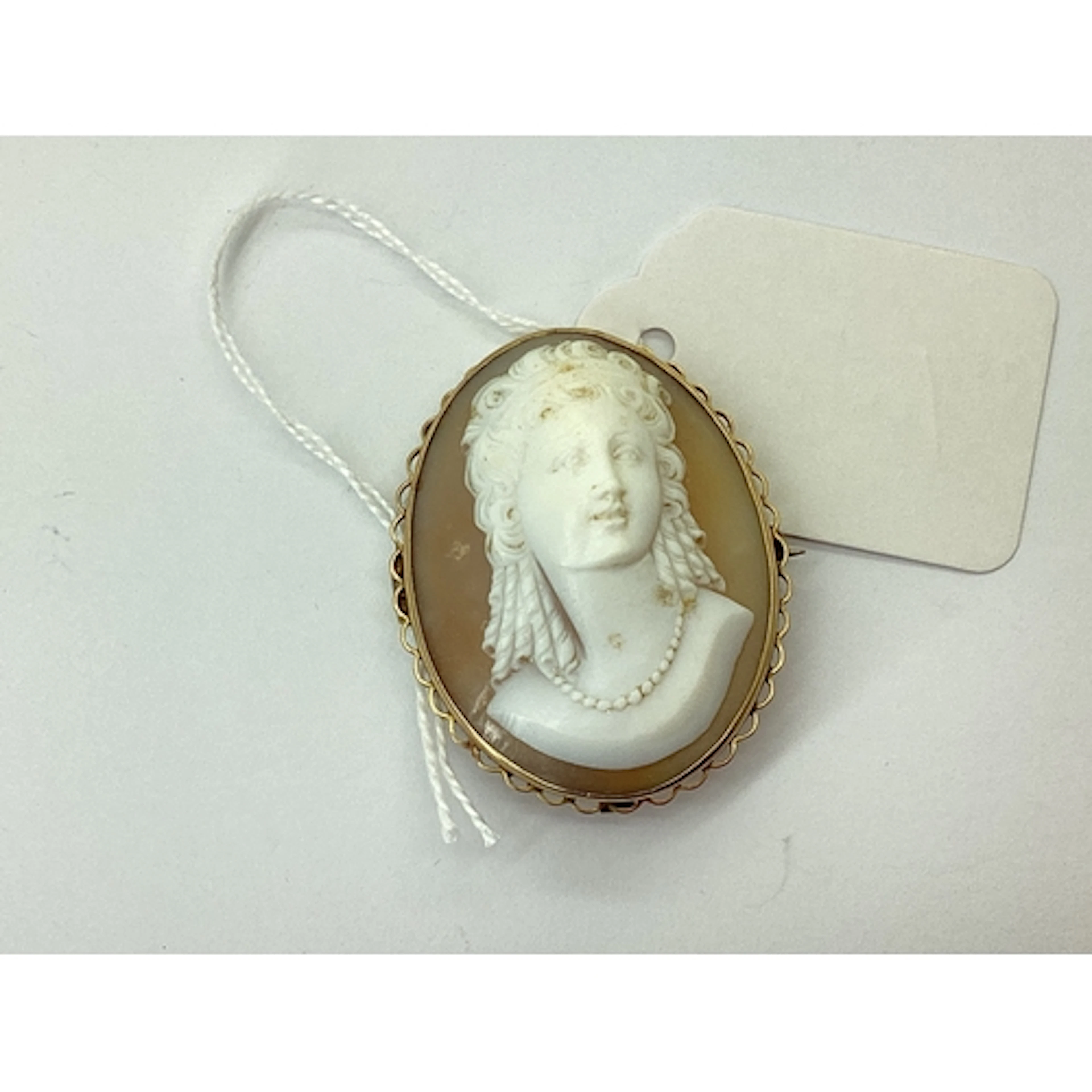 An Oval Shell Carved Cameo Brooch, depicting female profile ...