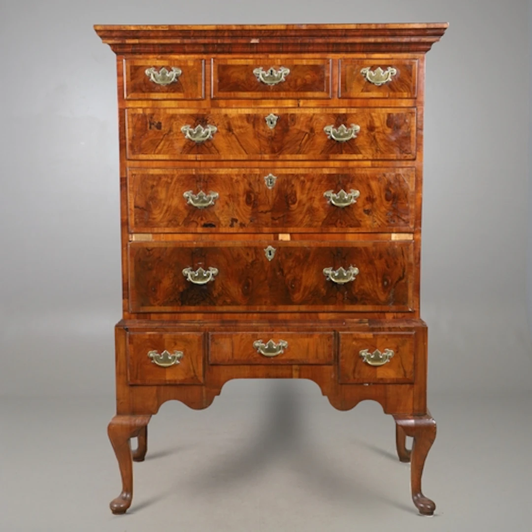 AN 18TH CENTURY WALNUT CHEST ON STAND. the heavily moulded c...