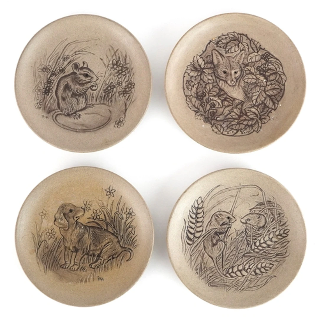 Four Poole Pottery dishes incised with animals, 13cm in diam...