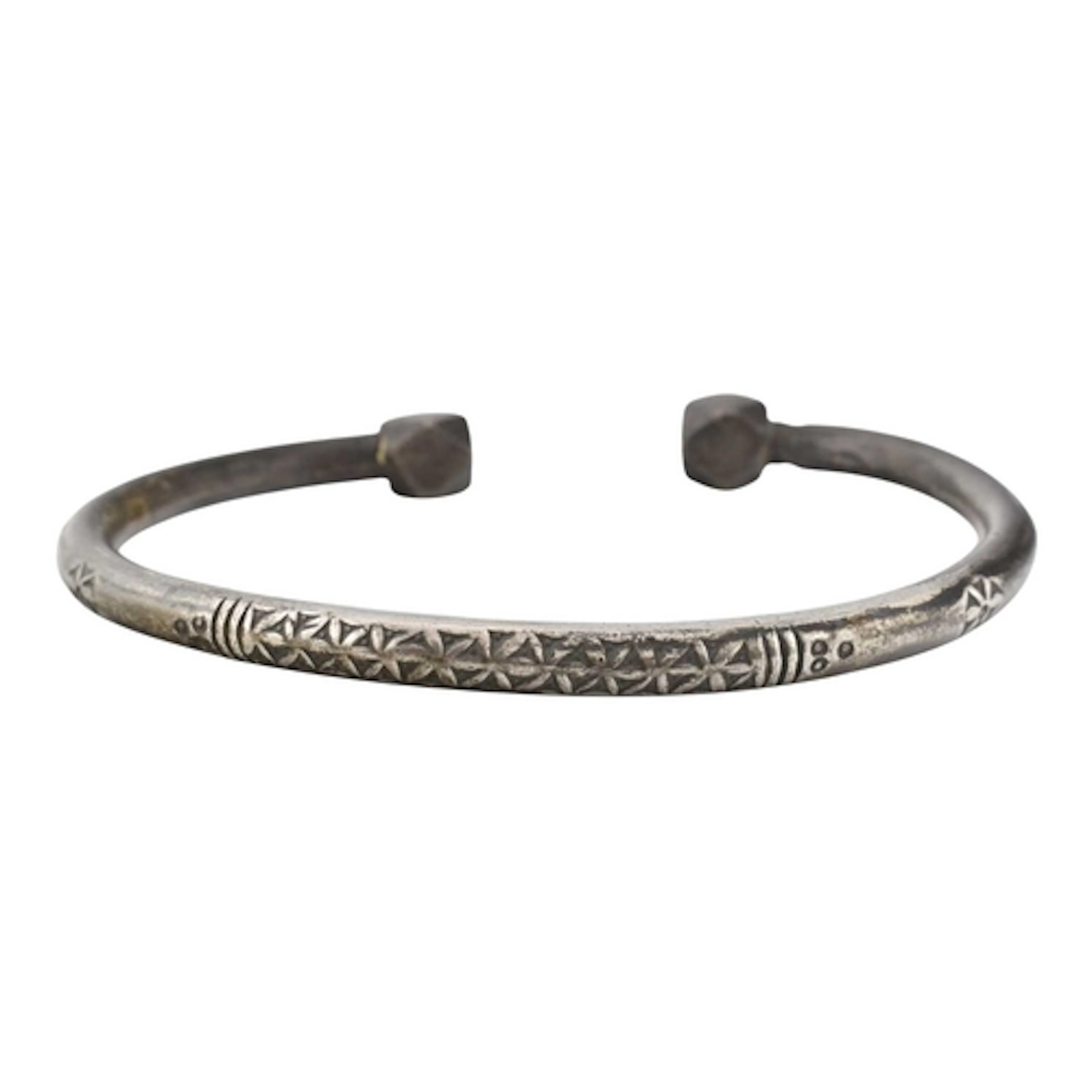 A heavy white metal bangle with geometric block terminals an...