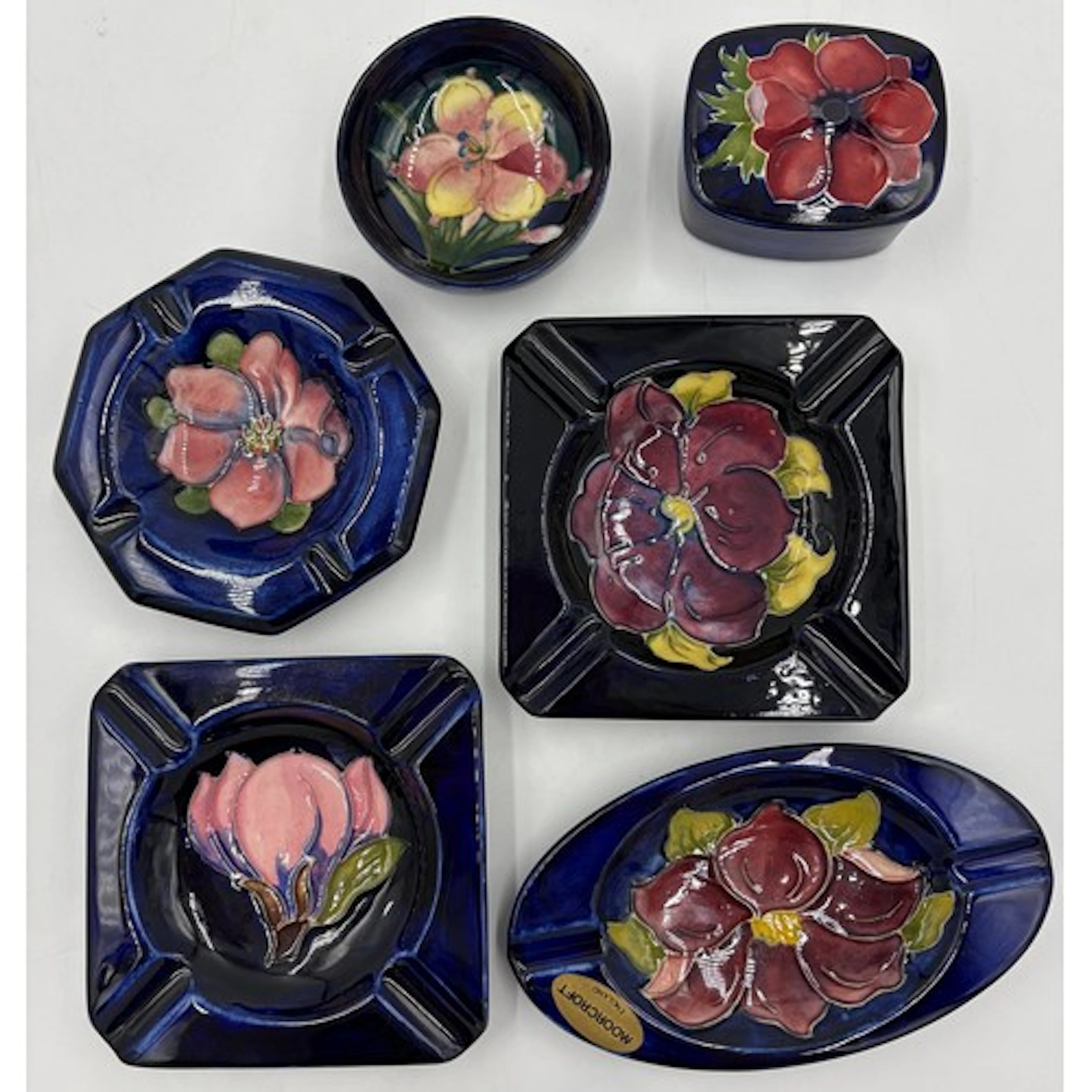 A collection of Moorcroft pottery to include 4 x ashtrays in...