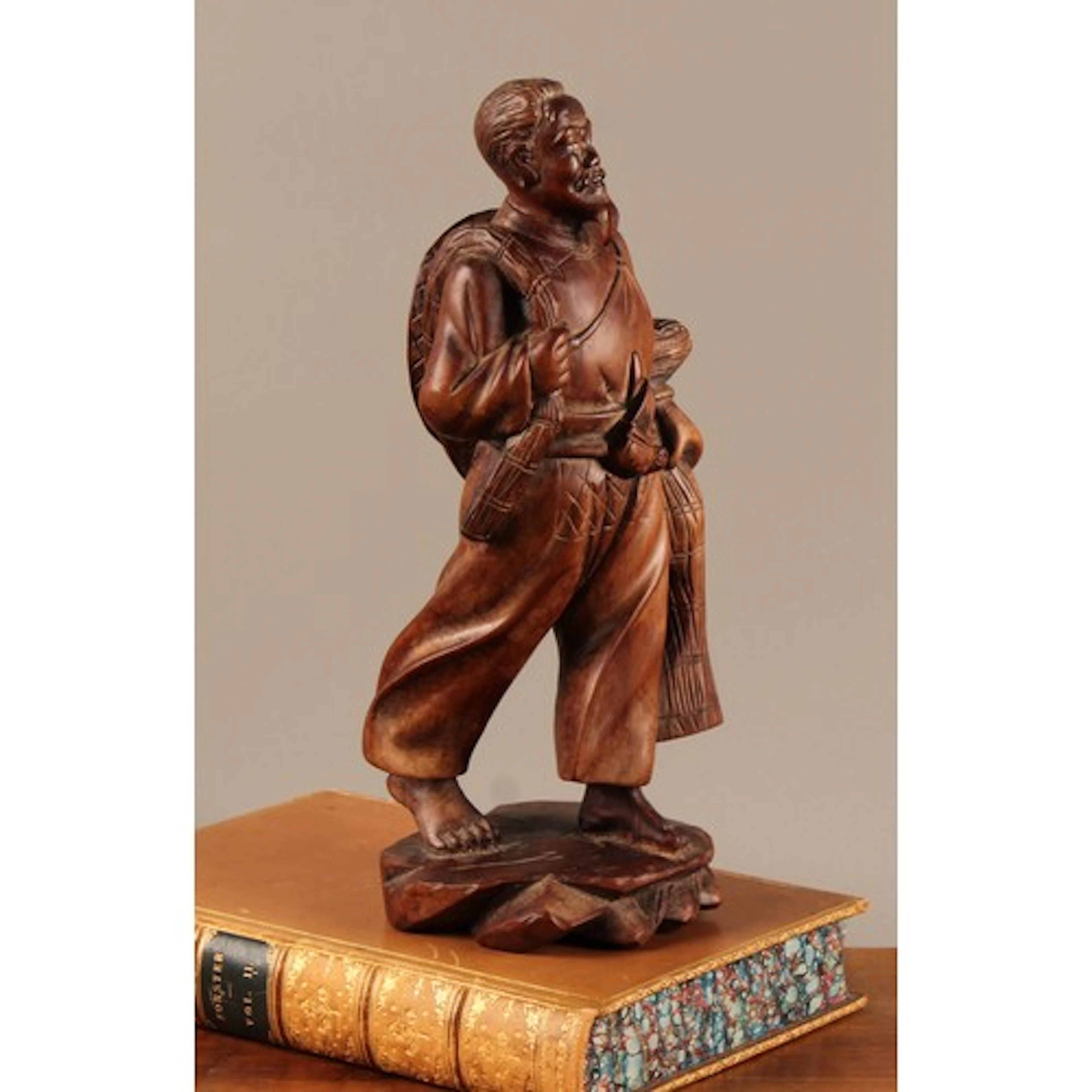 A Japanese hardwood carving, of a fisherman, 26cm high, earl...