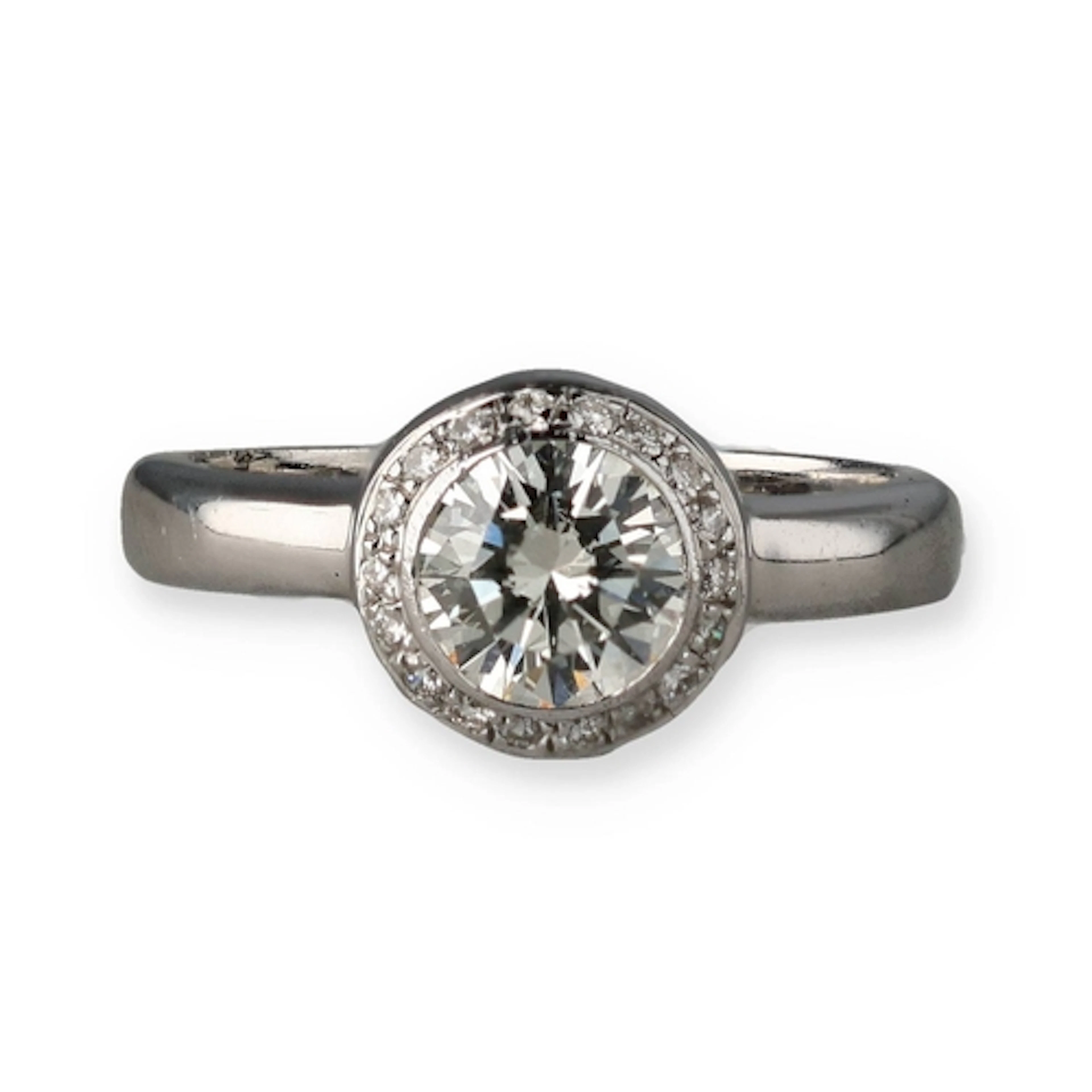 AN 18CT WHITE GOLD AND DIAMOND RING With central diamond sur...