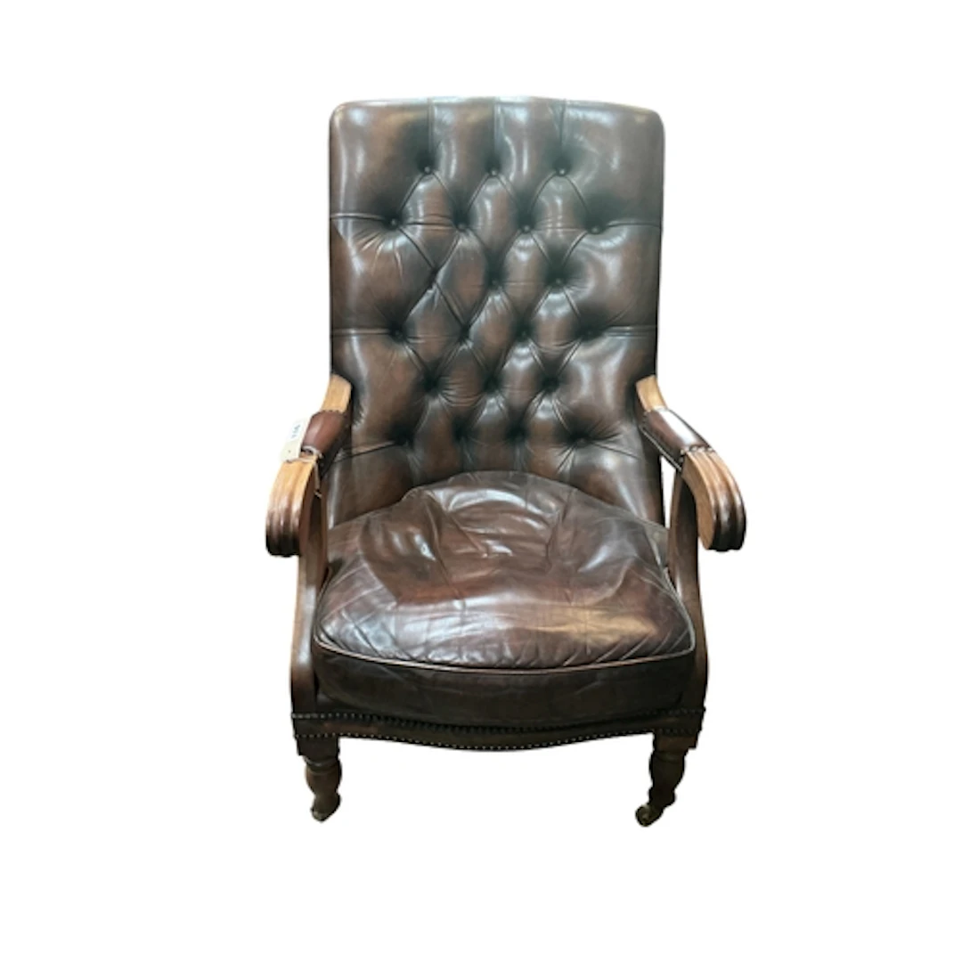 A Victorian mahogany and buttoned brown leather open armchai...