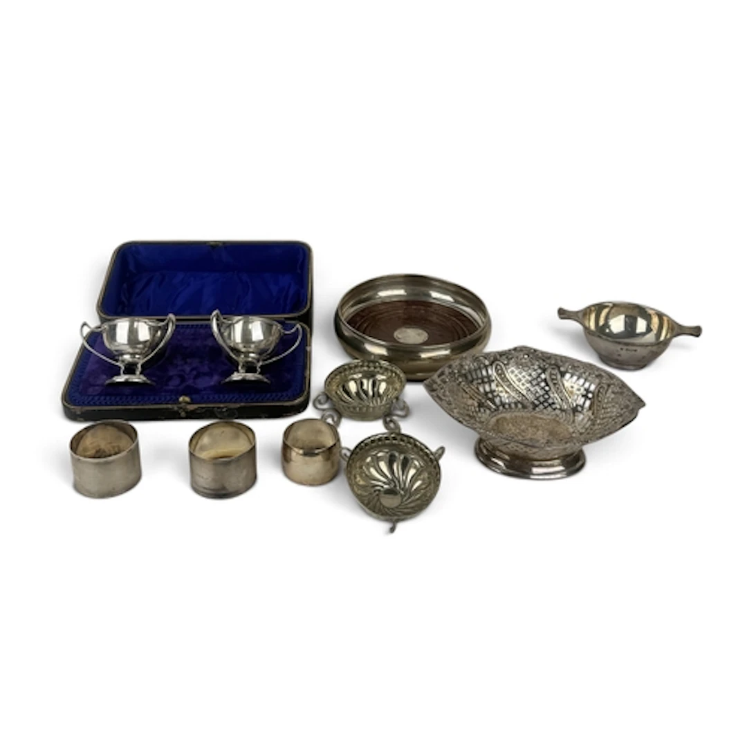 A GROUP OF SILVER To include a pair of salts (boxed), a reti...
