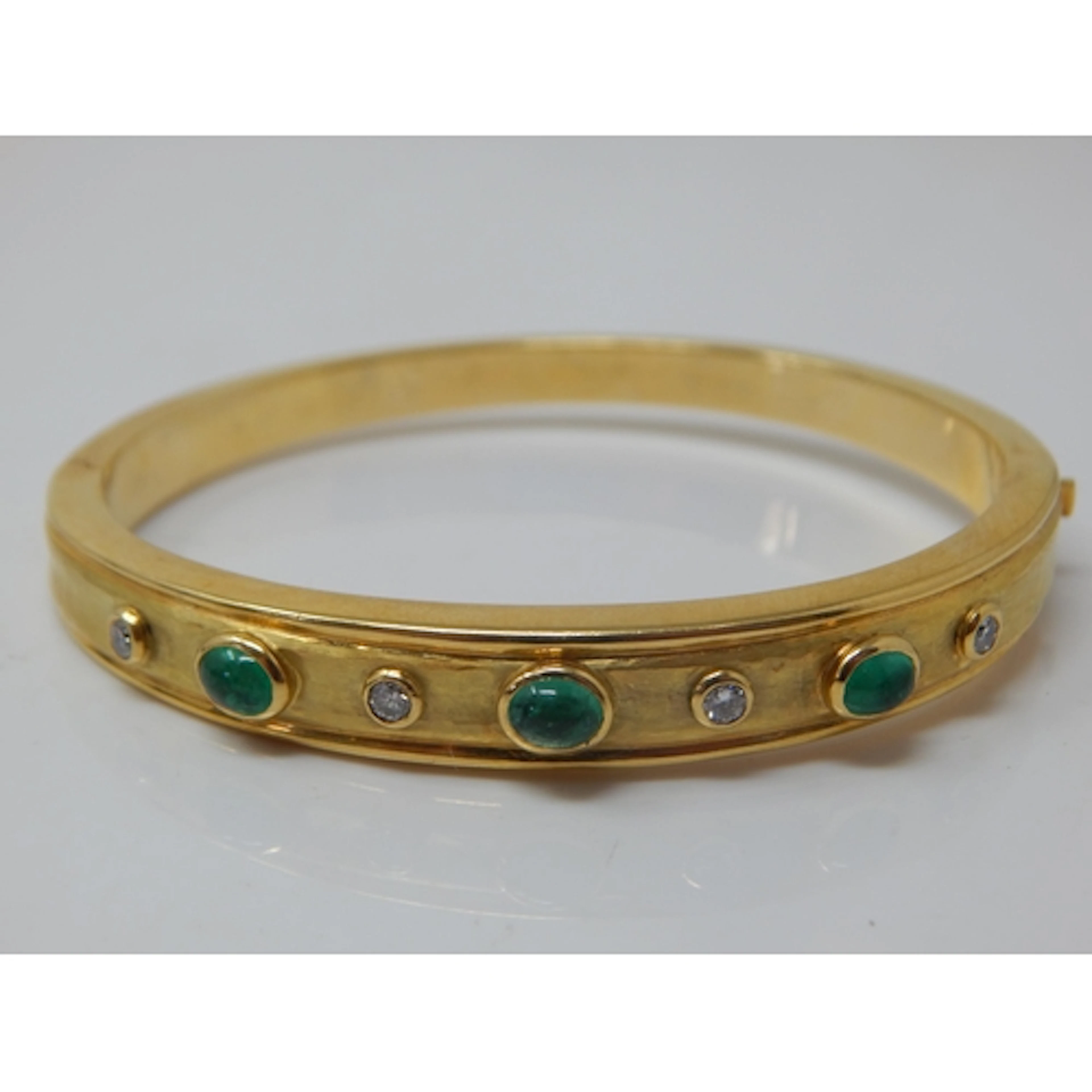 GARRARD: 18ct Gold Hinged Hollow Bangle Set with Three Caboc...