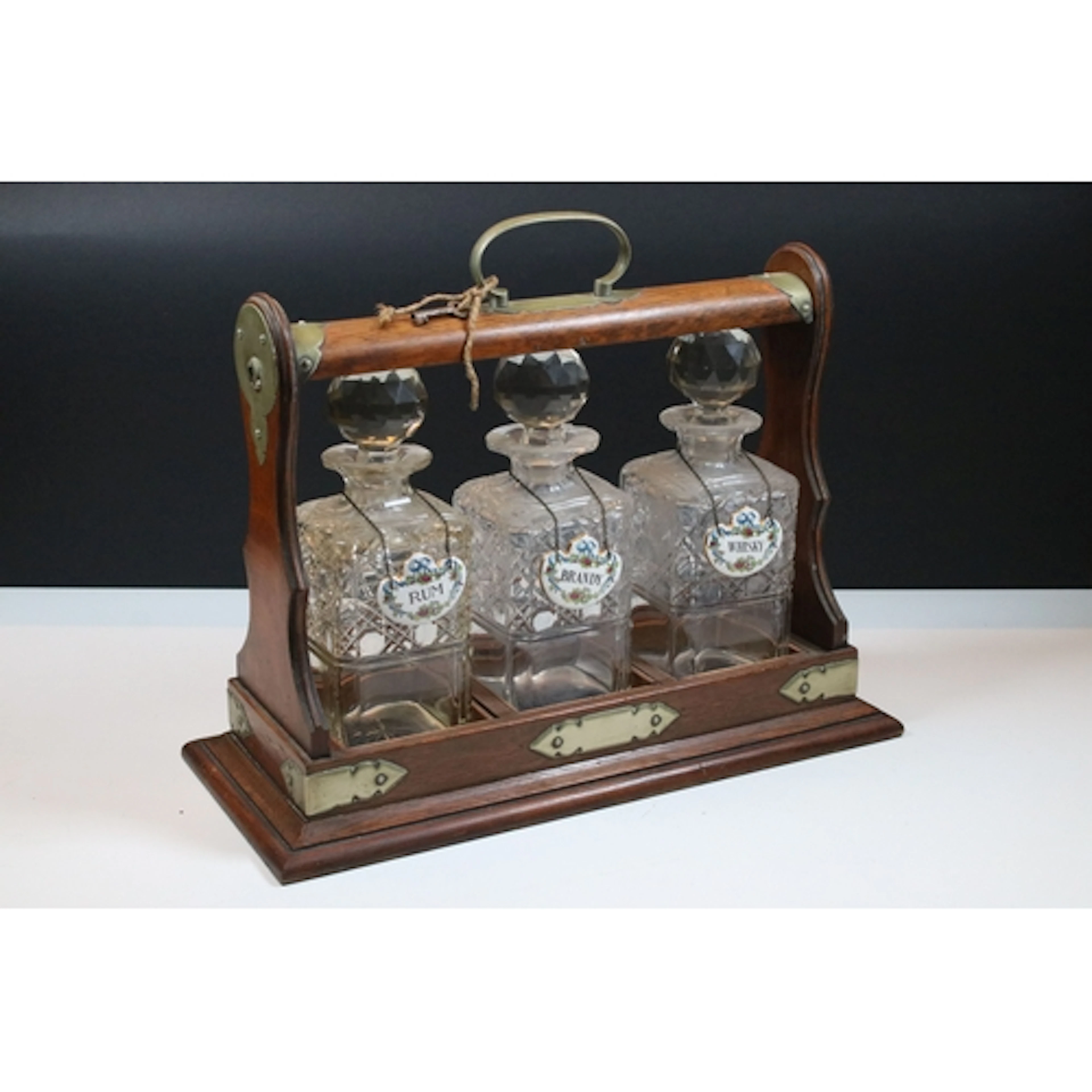 Early 20th century oak cased tantalus, with metal mounts and...