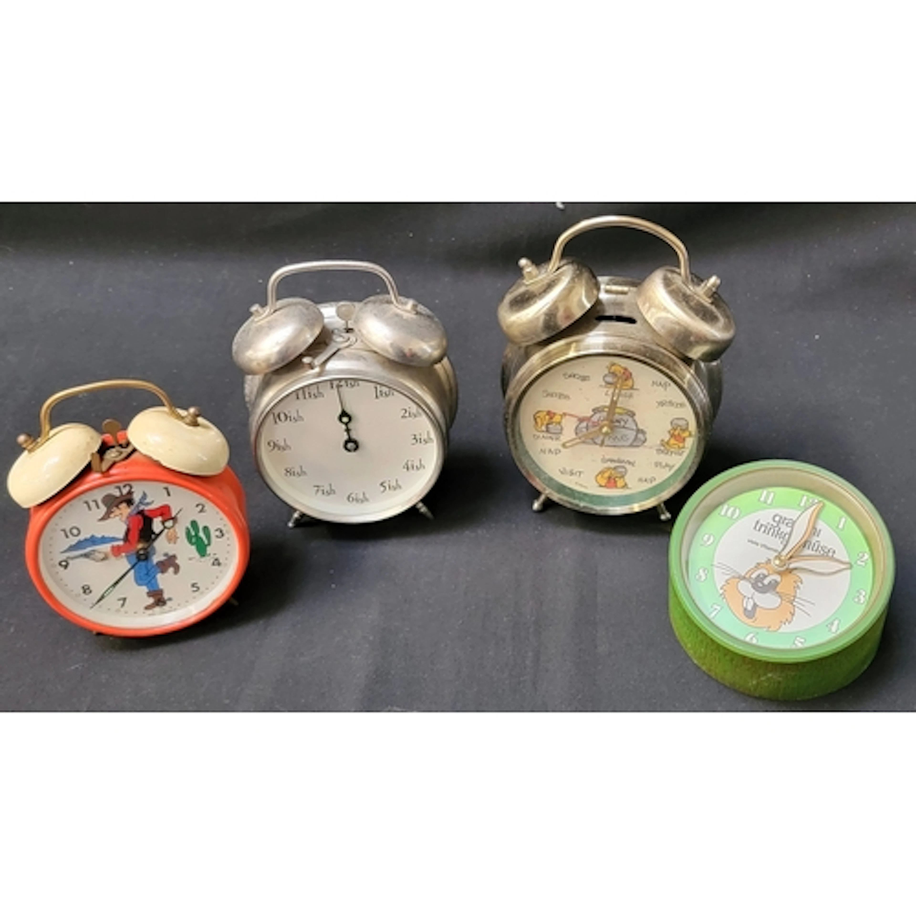 FOUR VINTAGE NOVELTY ALARM CLOCKS comprising a Winnie the Po...