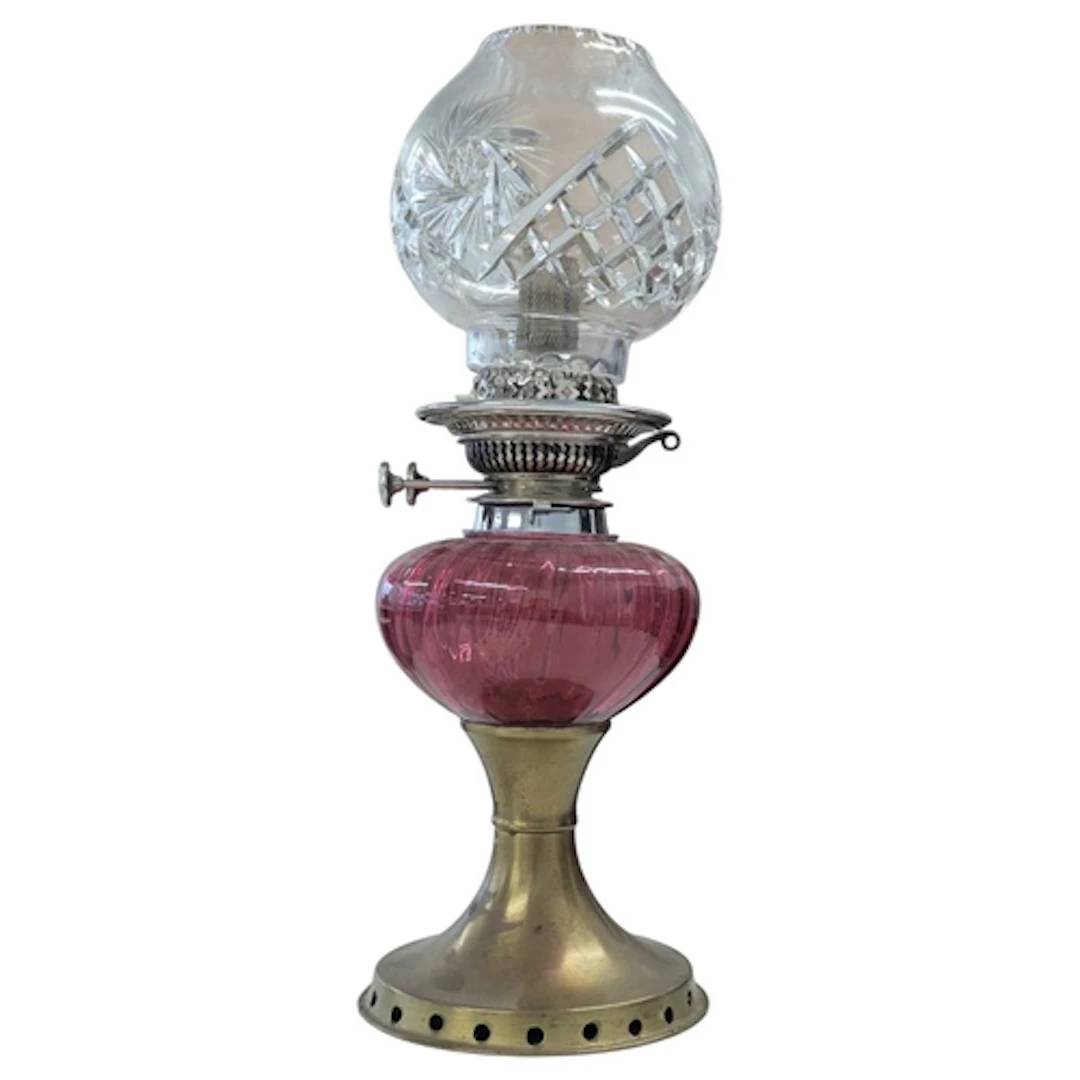 An early 20th century oil lamp. The lamp having brass base, ...