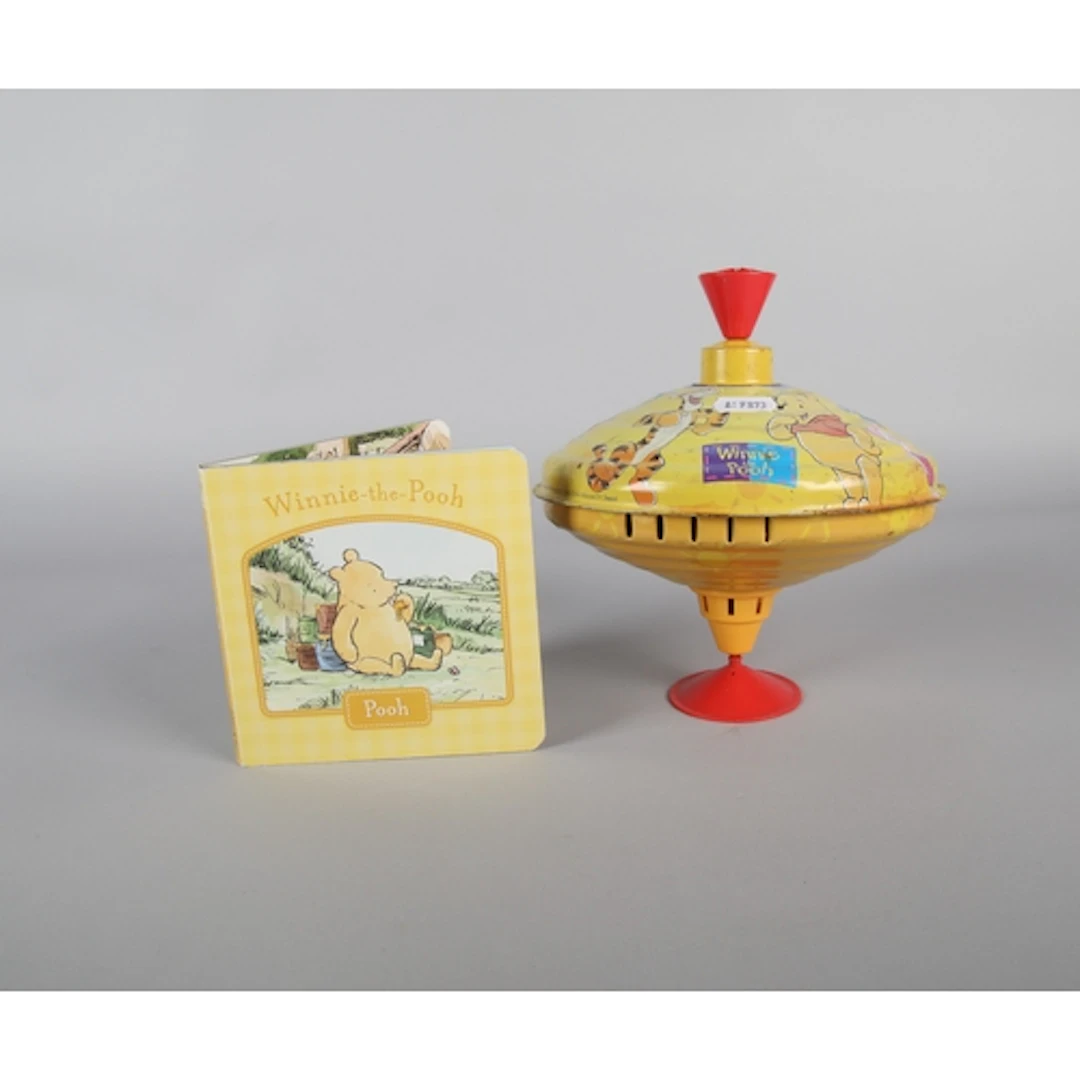 Winnie the Pooh book with a Winnie the Pooh spinning top.