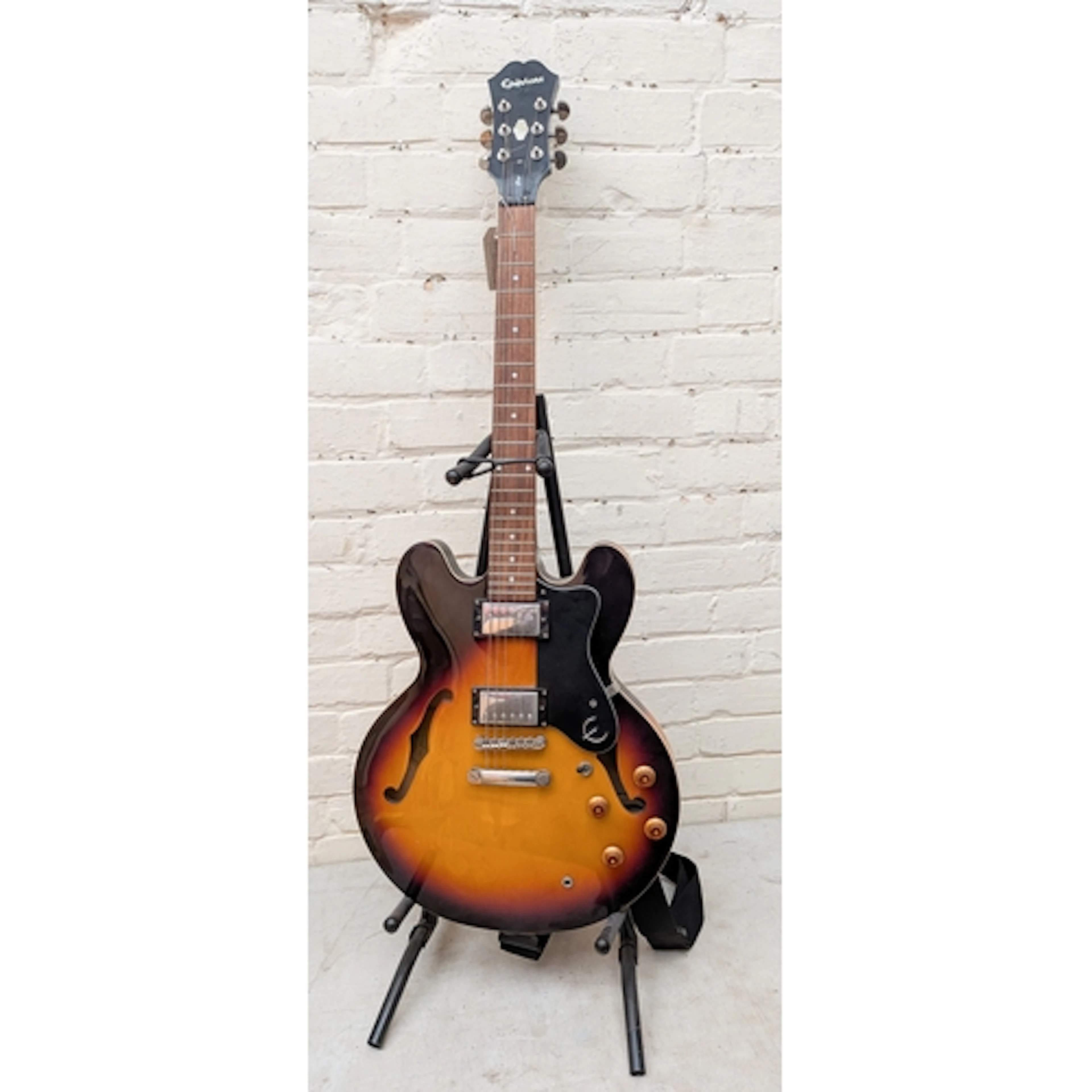 An Epiphone Dot electric guitar on a stand