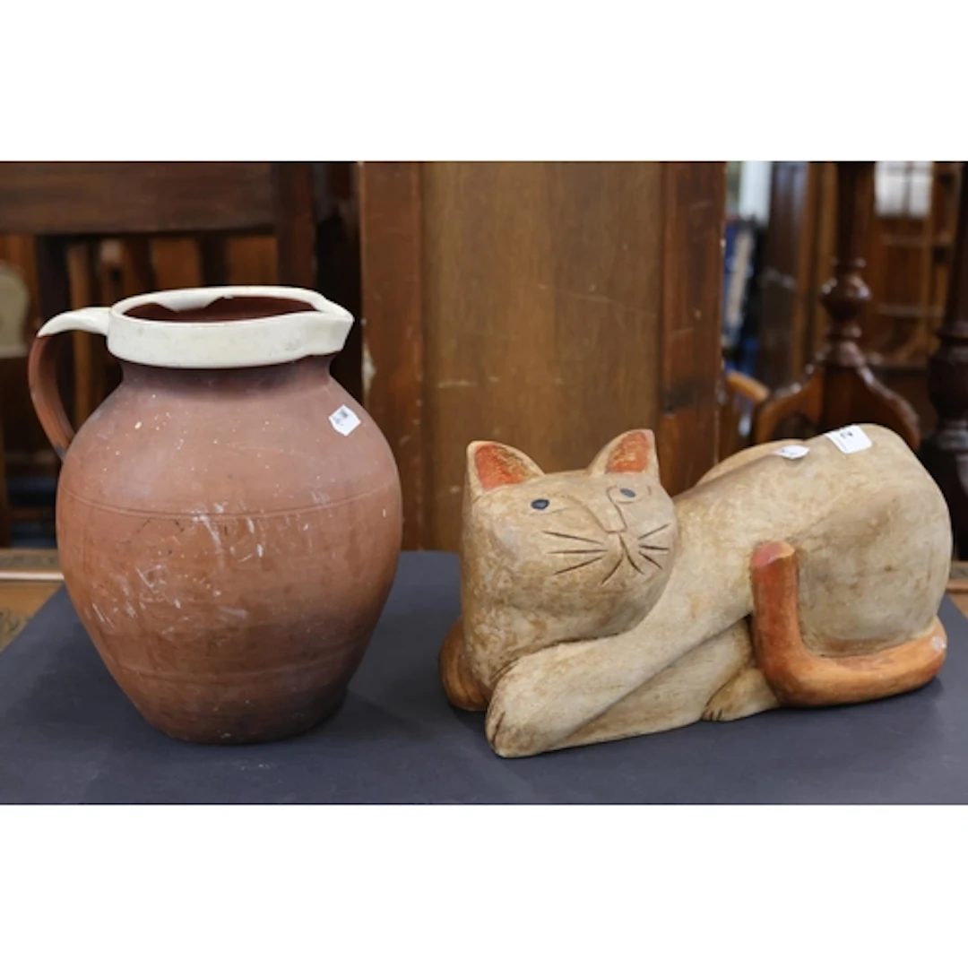 Carved wooden cat and a Barum ware unglazed jug.