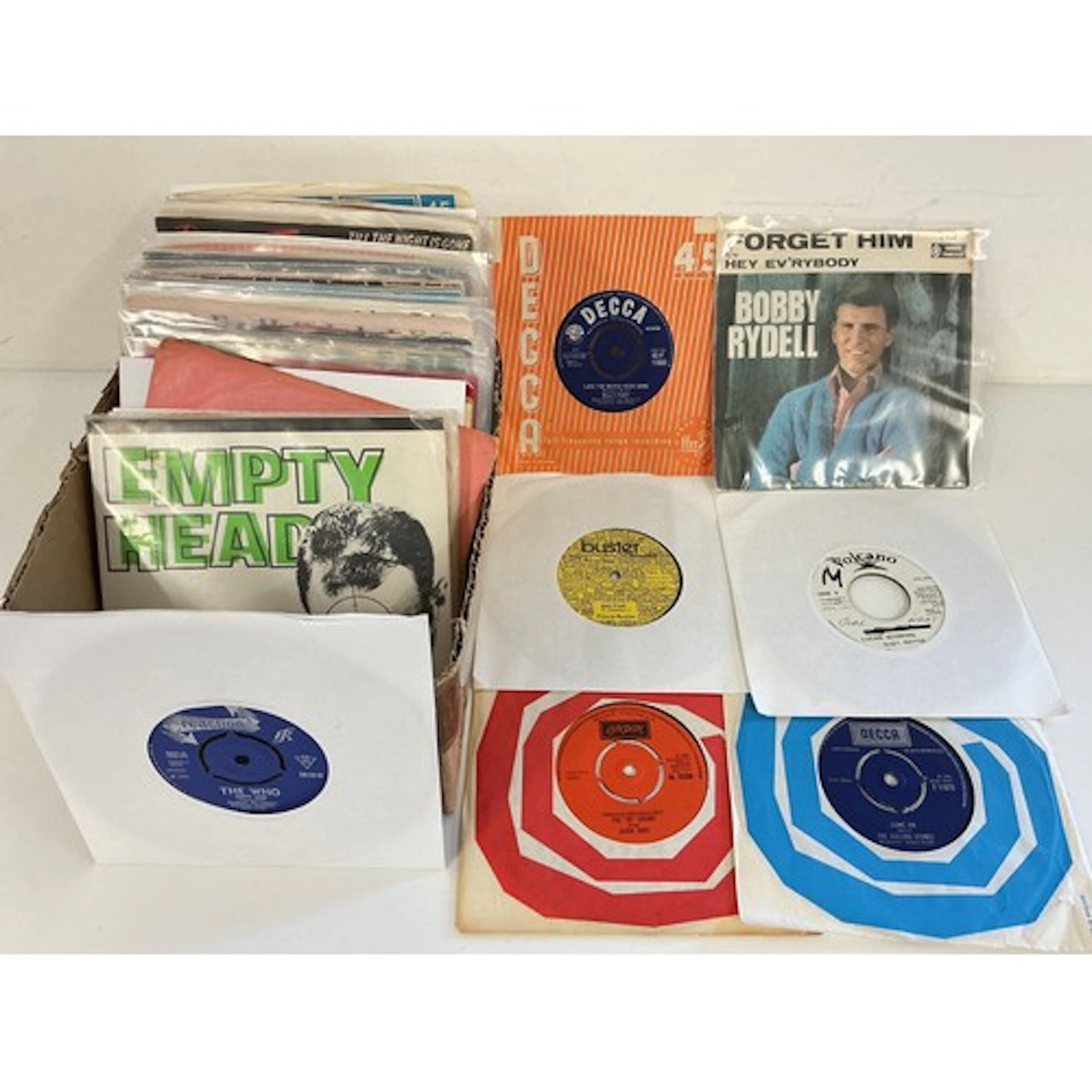 A collection of 7” singles by various artists including The ...