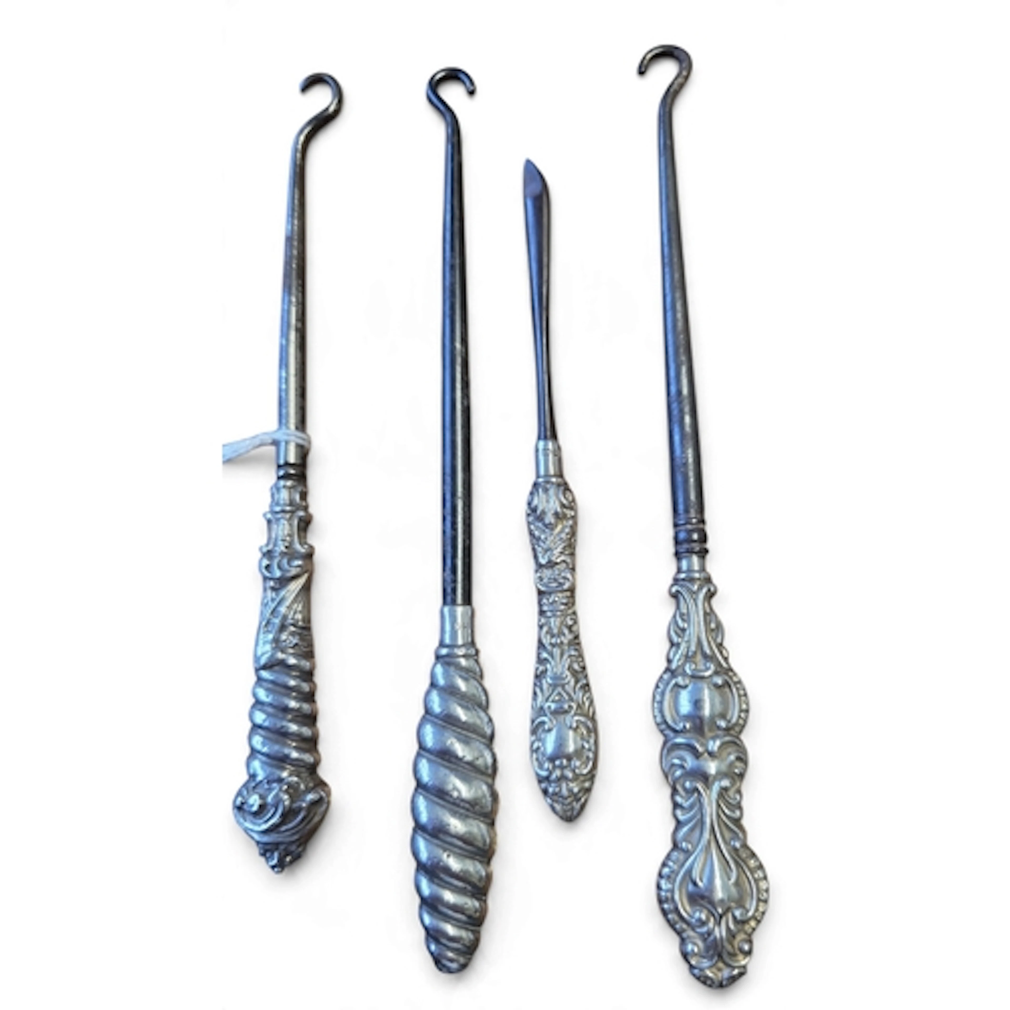 A group of four Silver handled Button Hooks and a sewing sti...