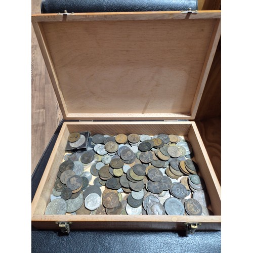 A wooden box of assorted world coins to include Victorian pe...