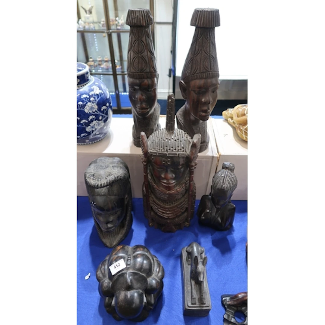 A group of African carved wood figure heads, a carved Chines...