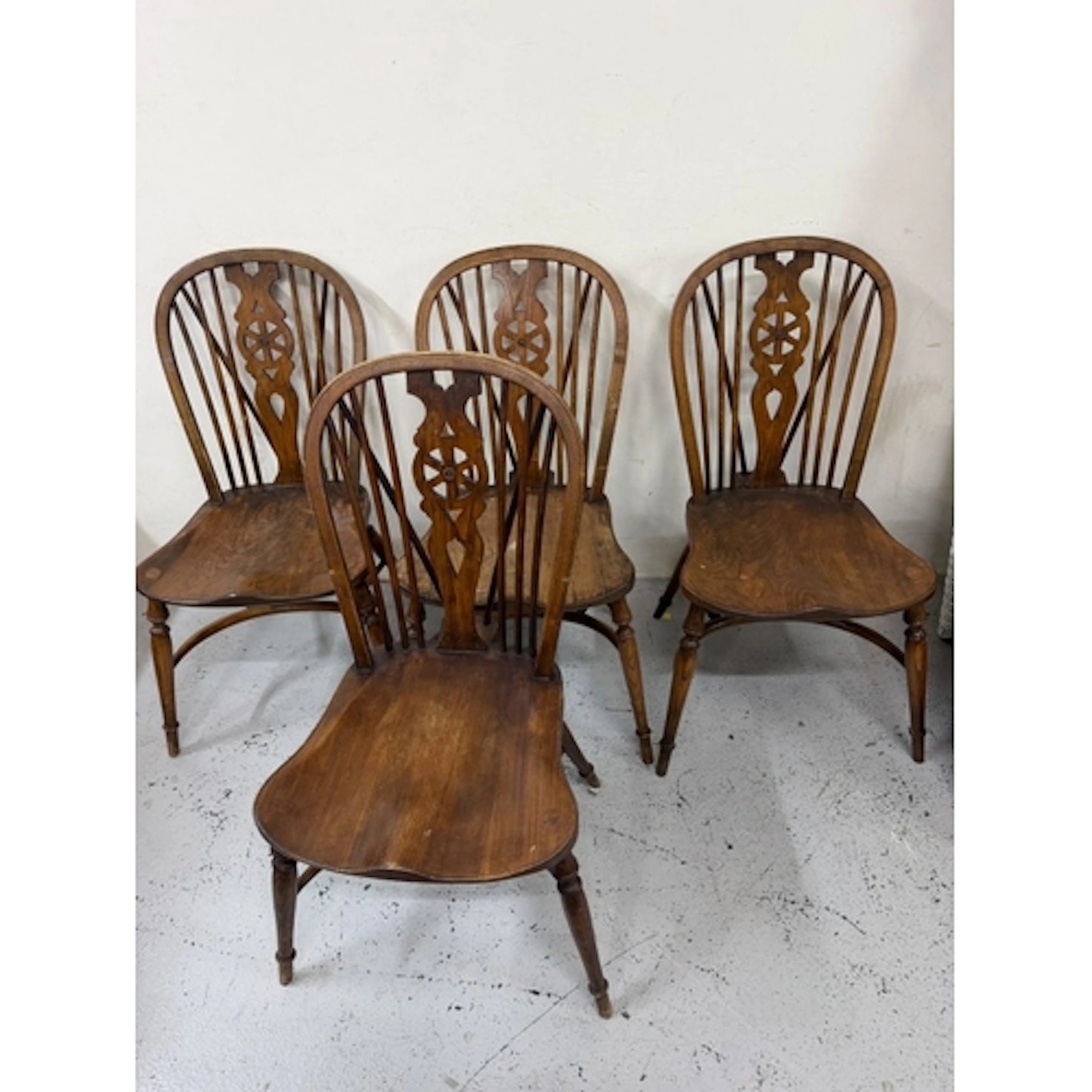Six wheel back chairs, ash and elm with bow stretchers...