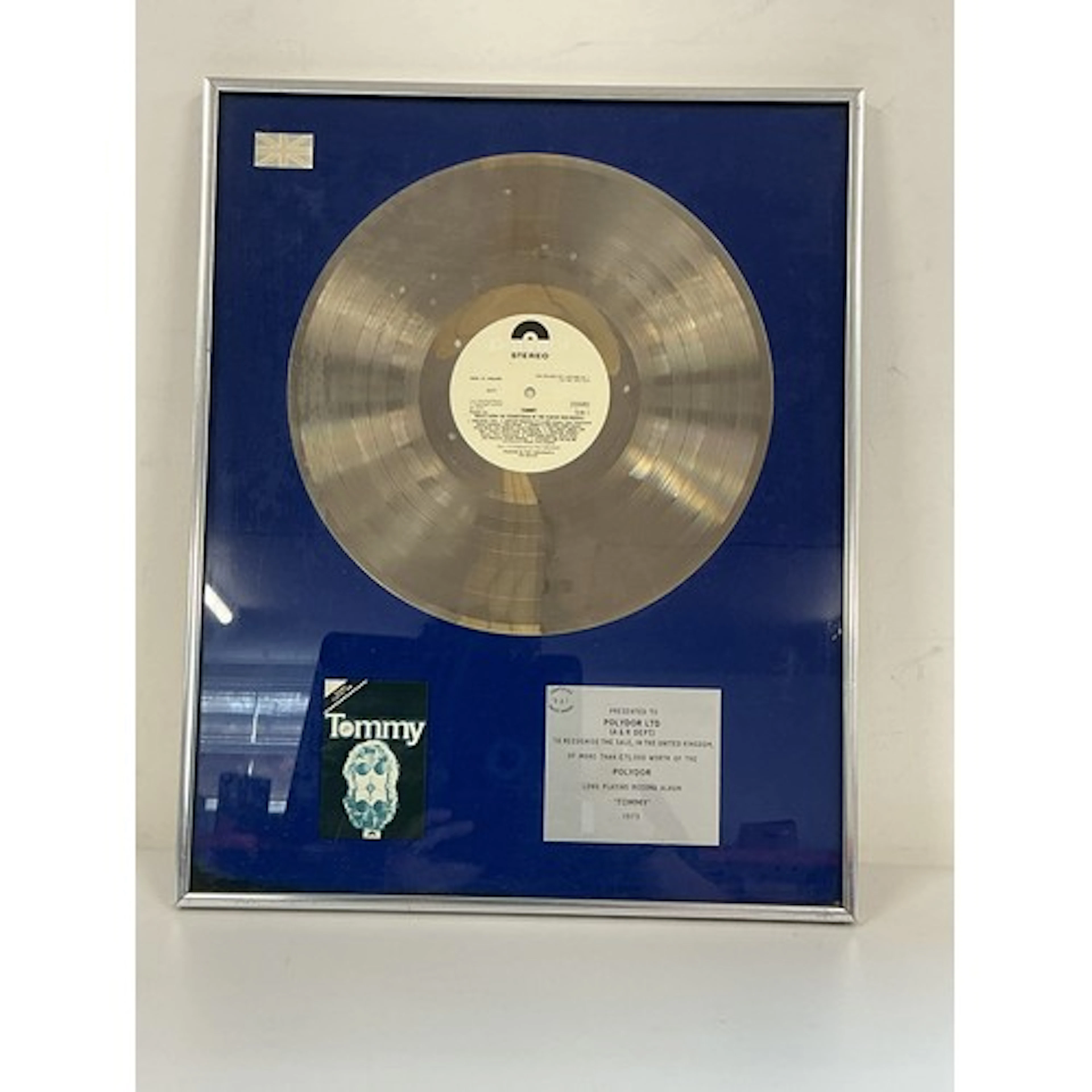 A framed and glazed silver disc presented to Polydor Records...