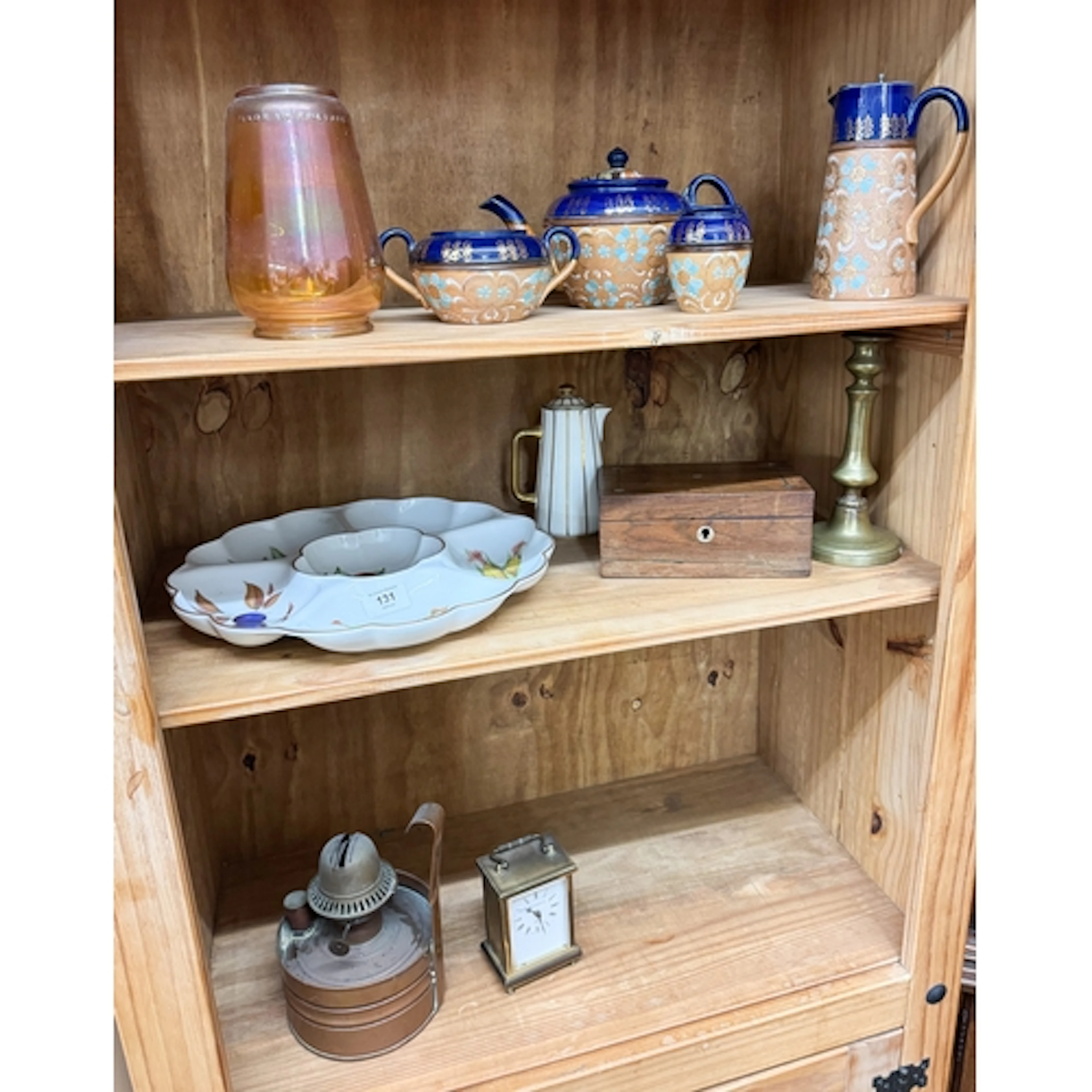 A four piece Doulton tea set together with a carriage clock,...