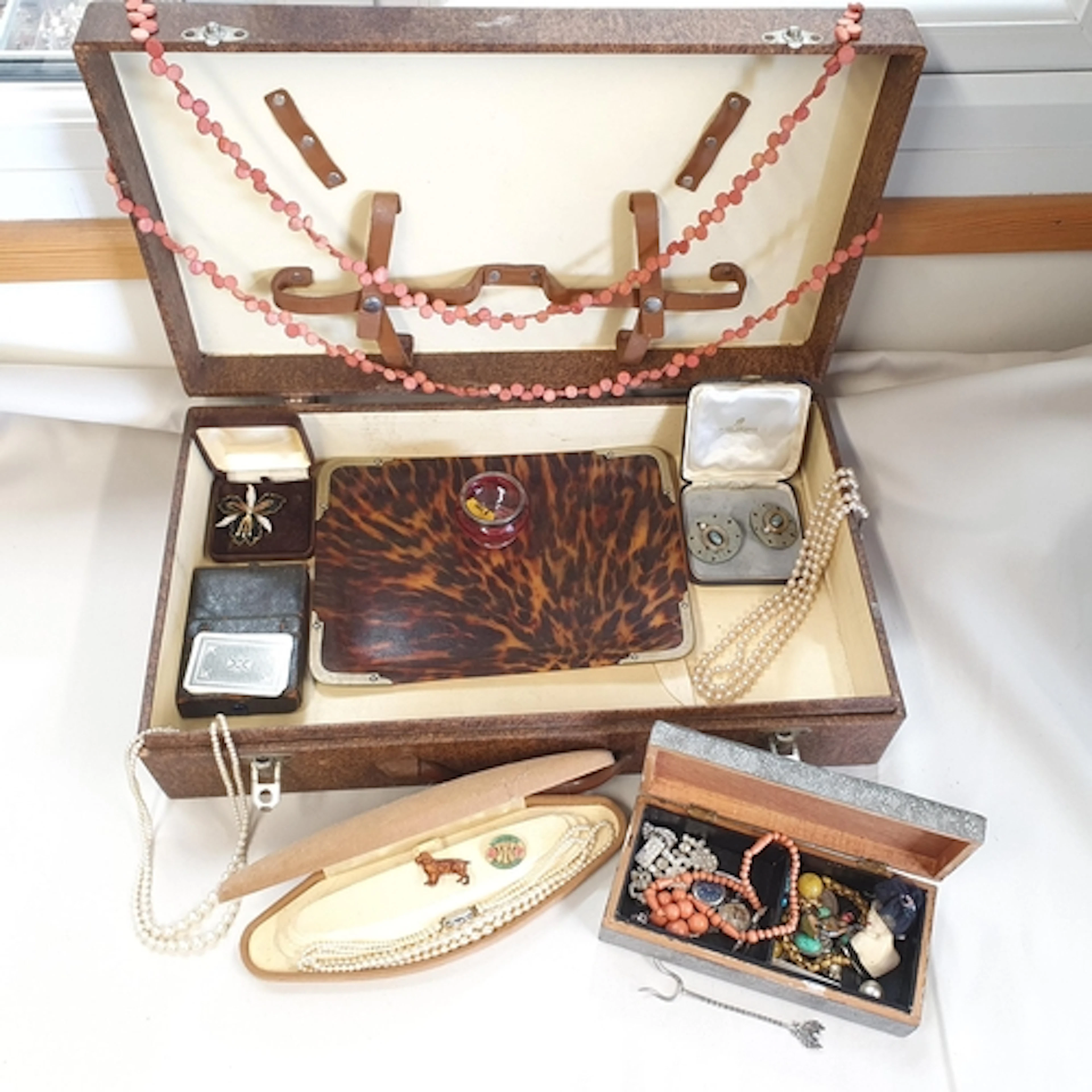 A vintage Suitcase containing various items of vintage Costu...