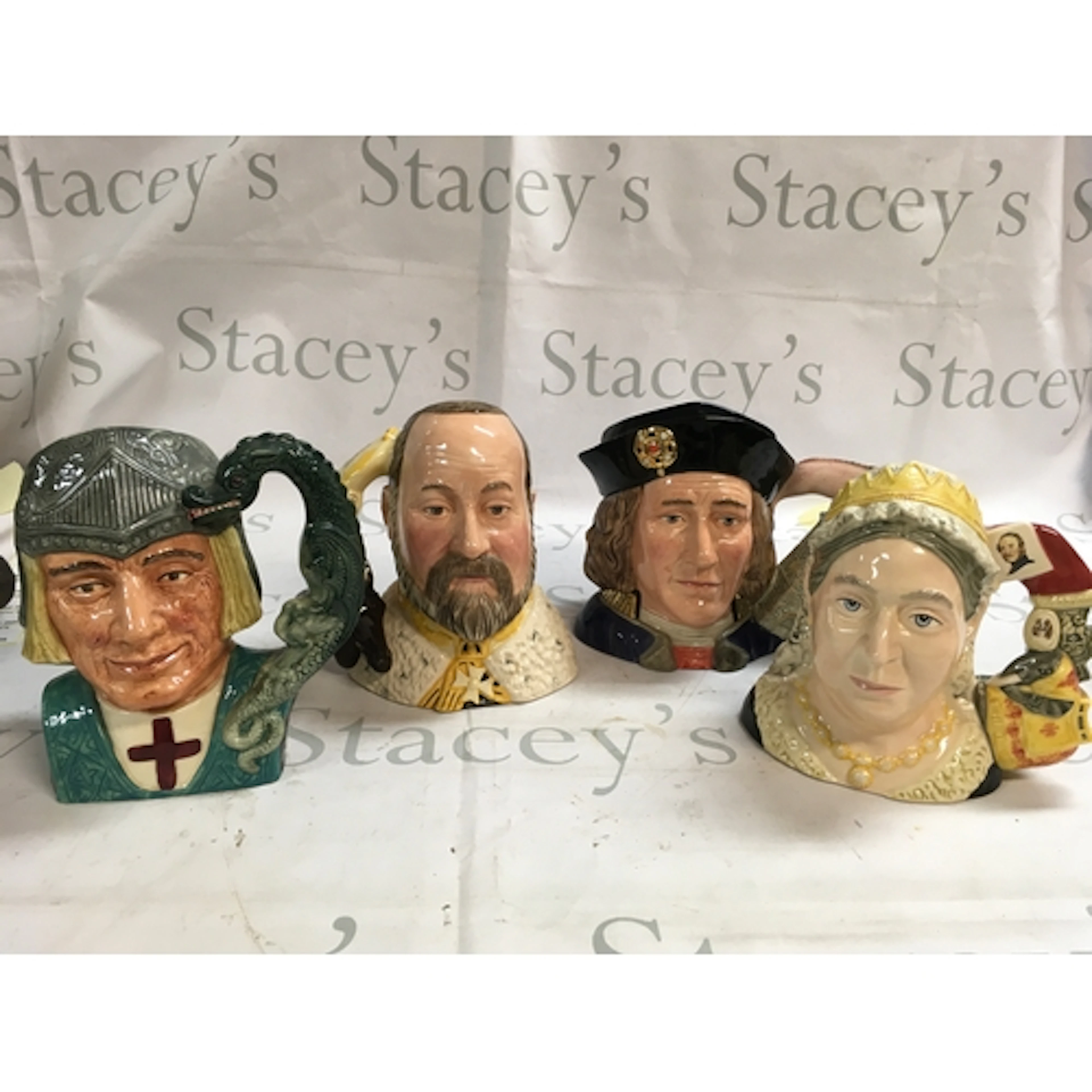 A collection of four Doulton Character jugs featuring monarc...