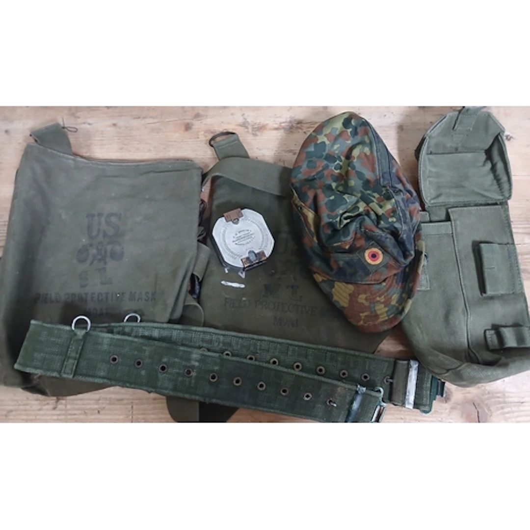 A US Army cap, belt, bags and a Bruntons compass.