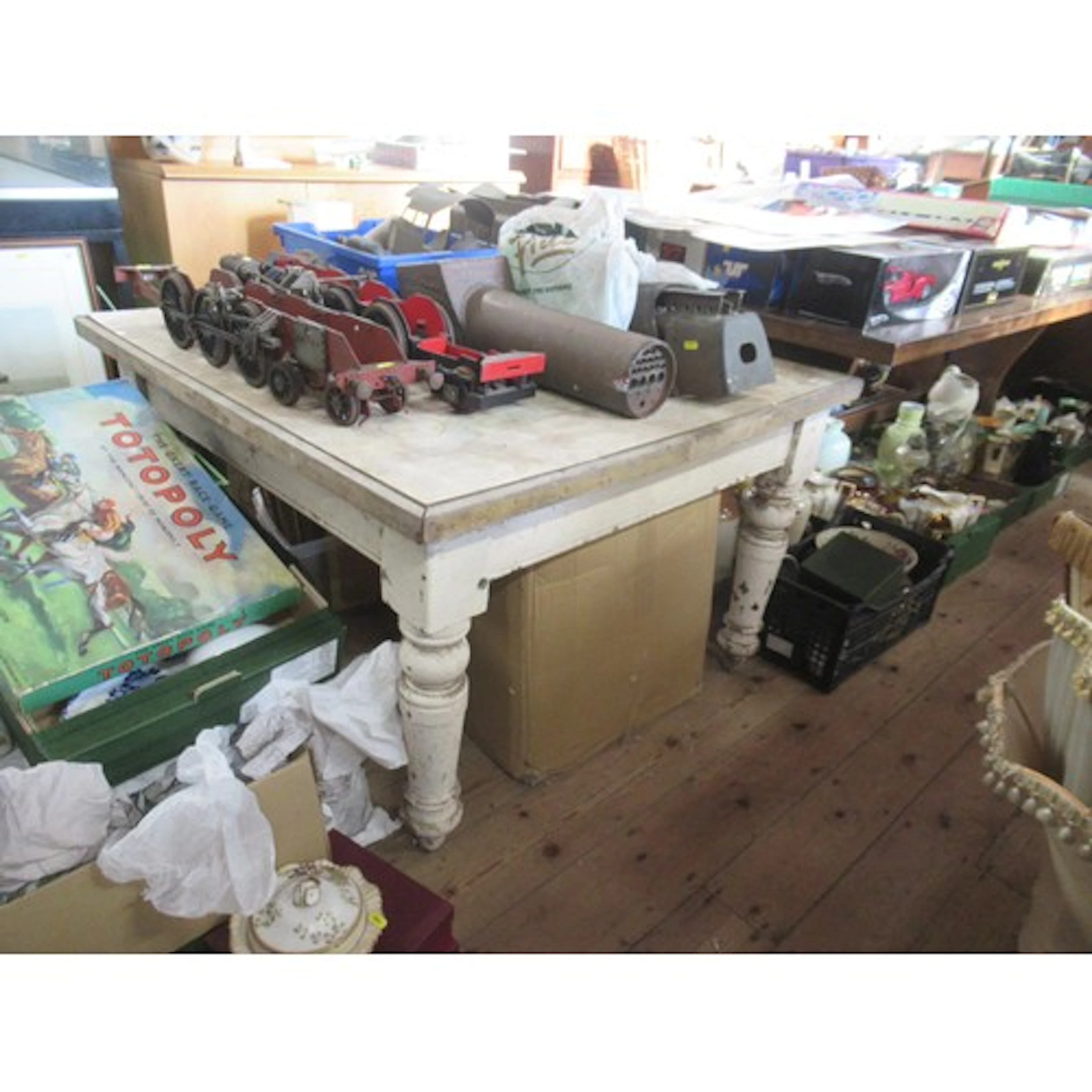 A painted kitchen table, in distressed condition, 44ins x 40...