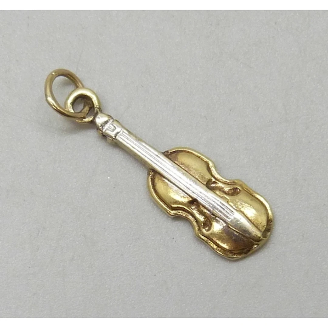 A yellow metal charm in the form of a violin, 1.2g, 2.4cm in...