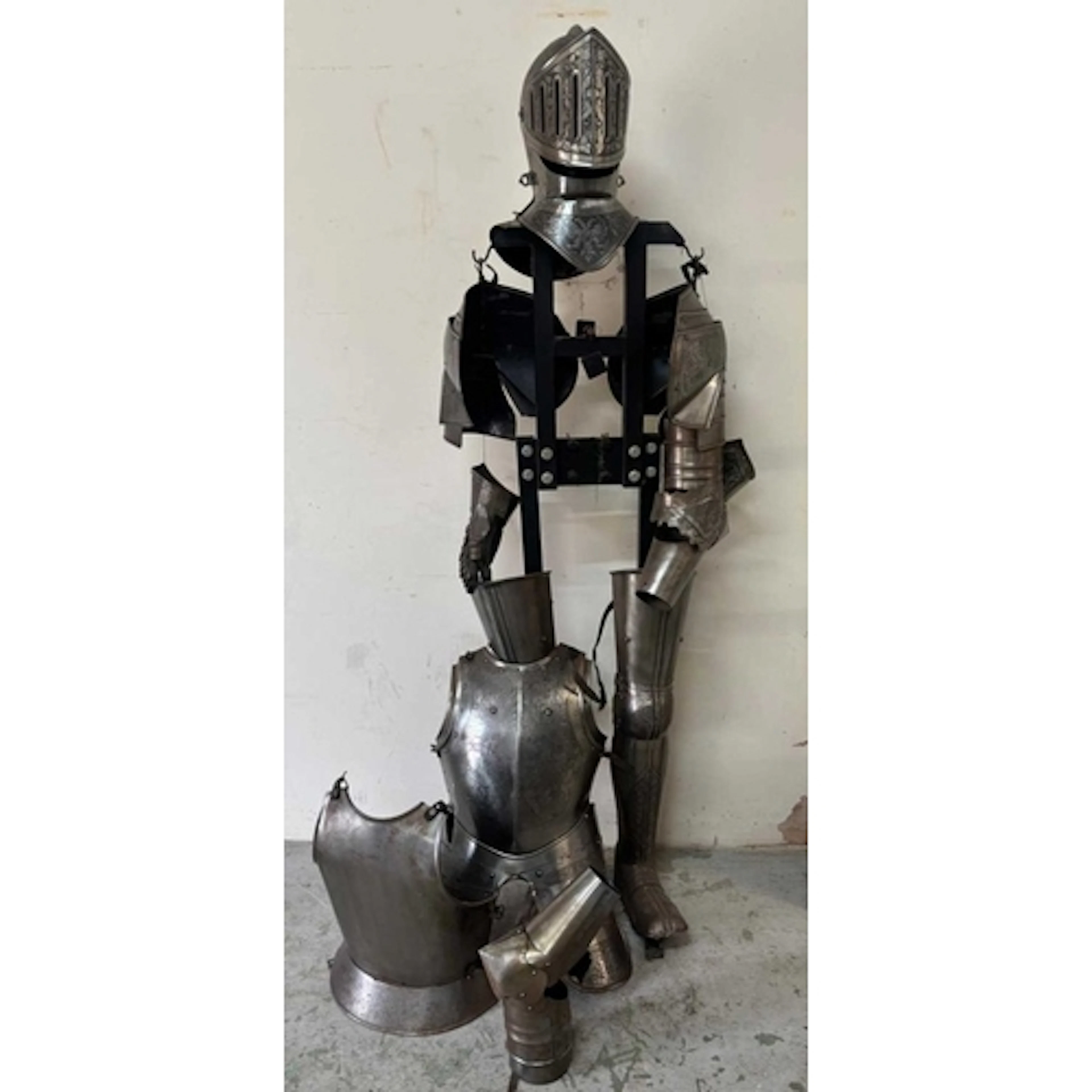 A Reproduction full suit of medieval armour on stand