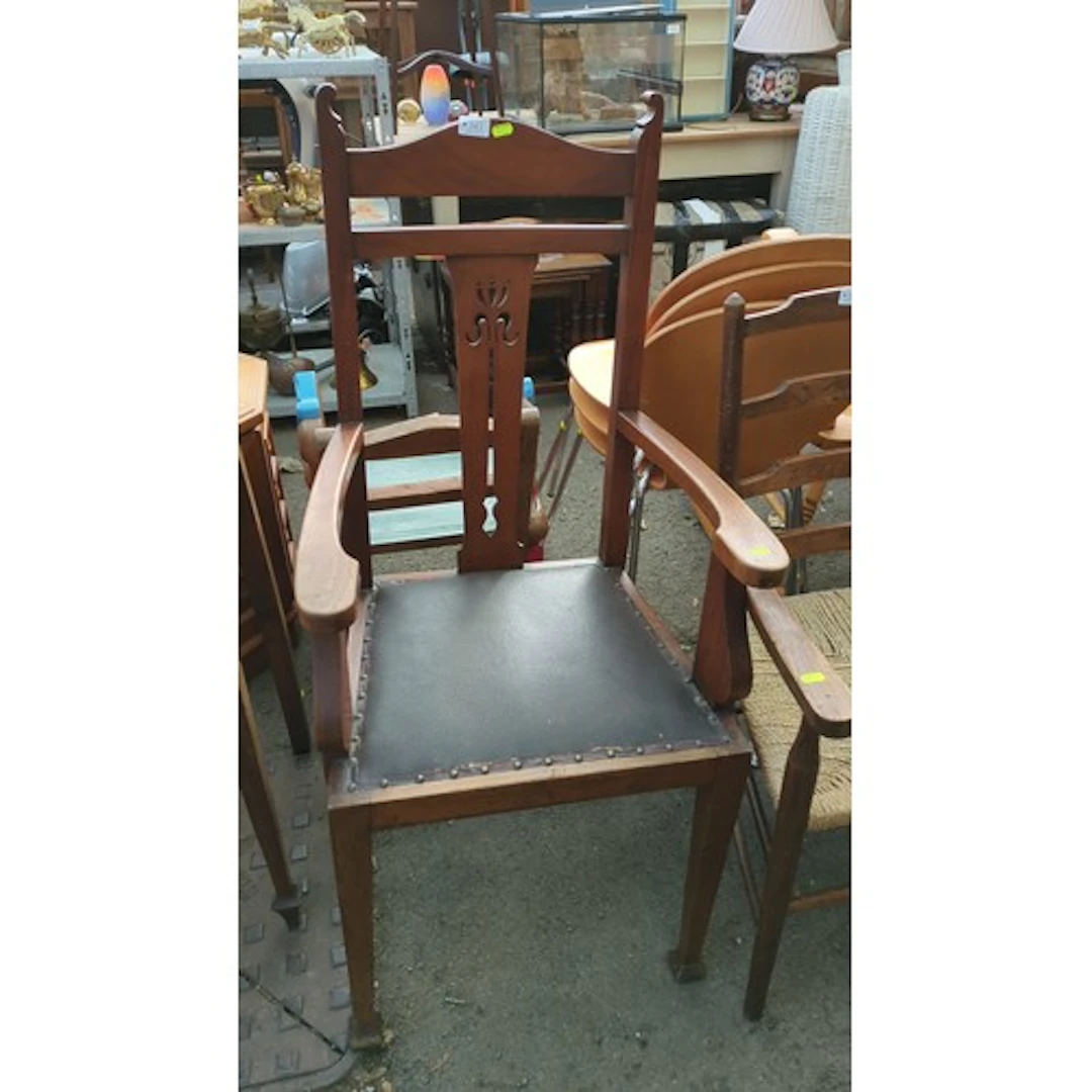 High-back stained-wood armchair with a shaped crest rail, pi...