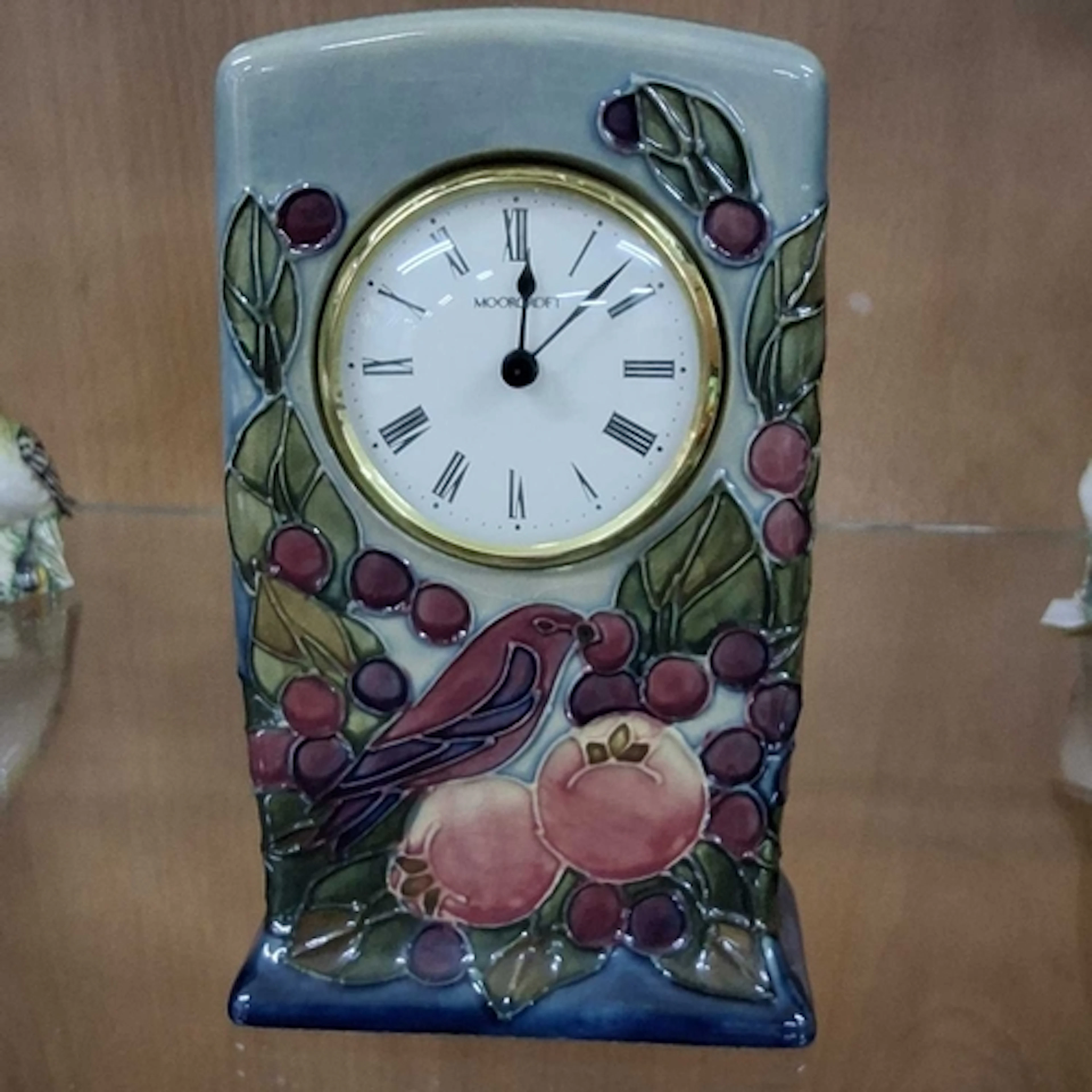 A MOORCROFT 'FINCHES' PATTERN CERAMIC MANTEL CLOCK, designed...