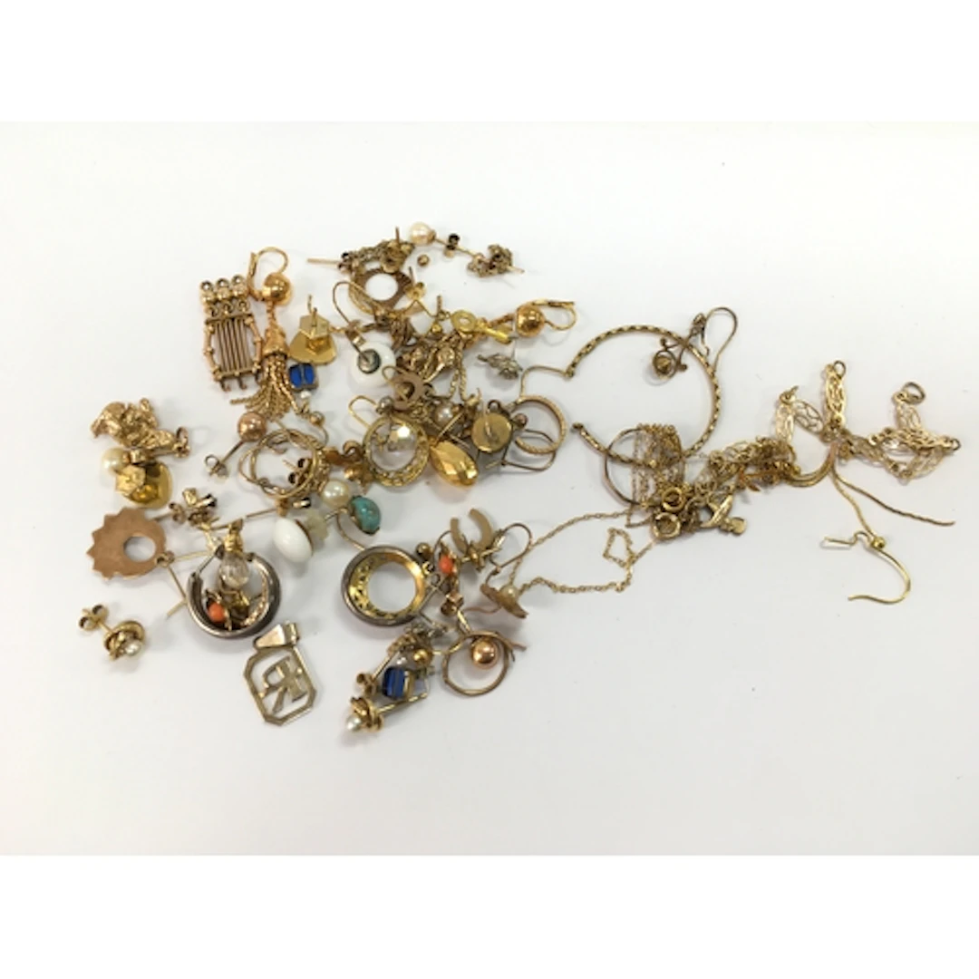 A collection of assorted gold items including earrings, pend...