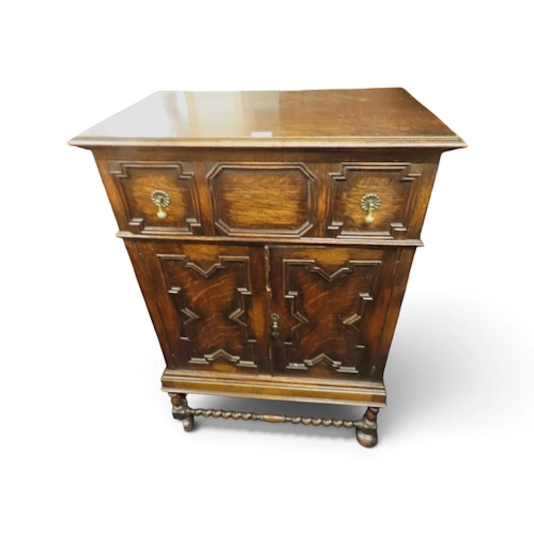 A 20th century oak Jacobean style low boy gents dresser with...