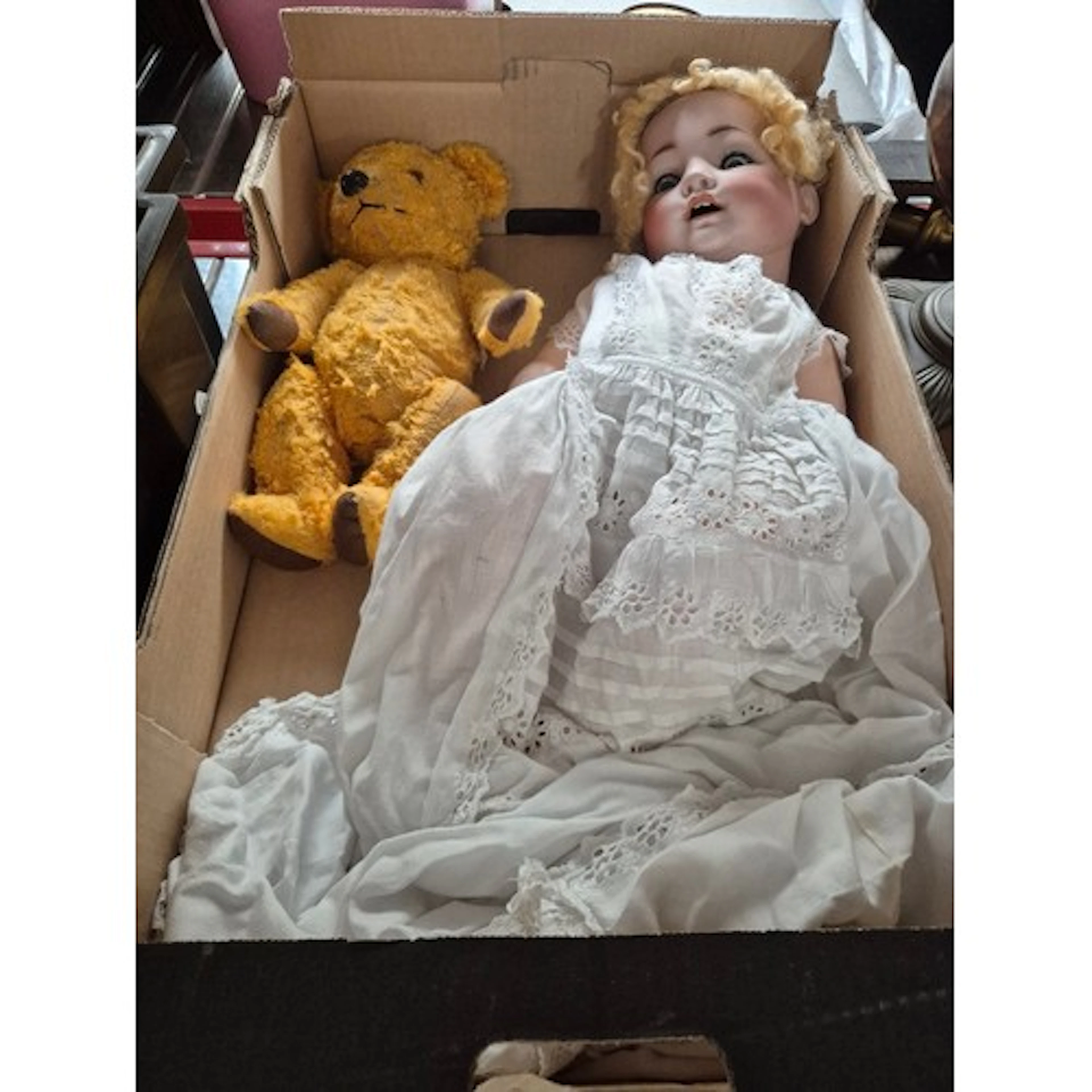 A German bisque headed doll in christening dress with a vint...