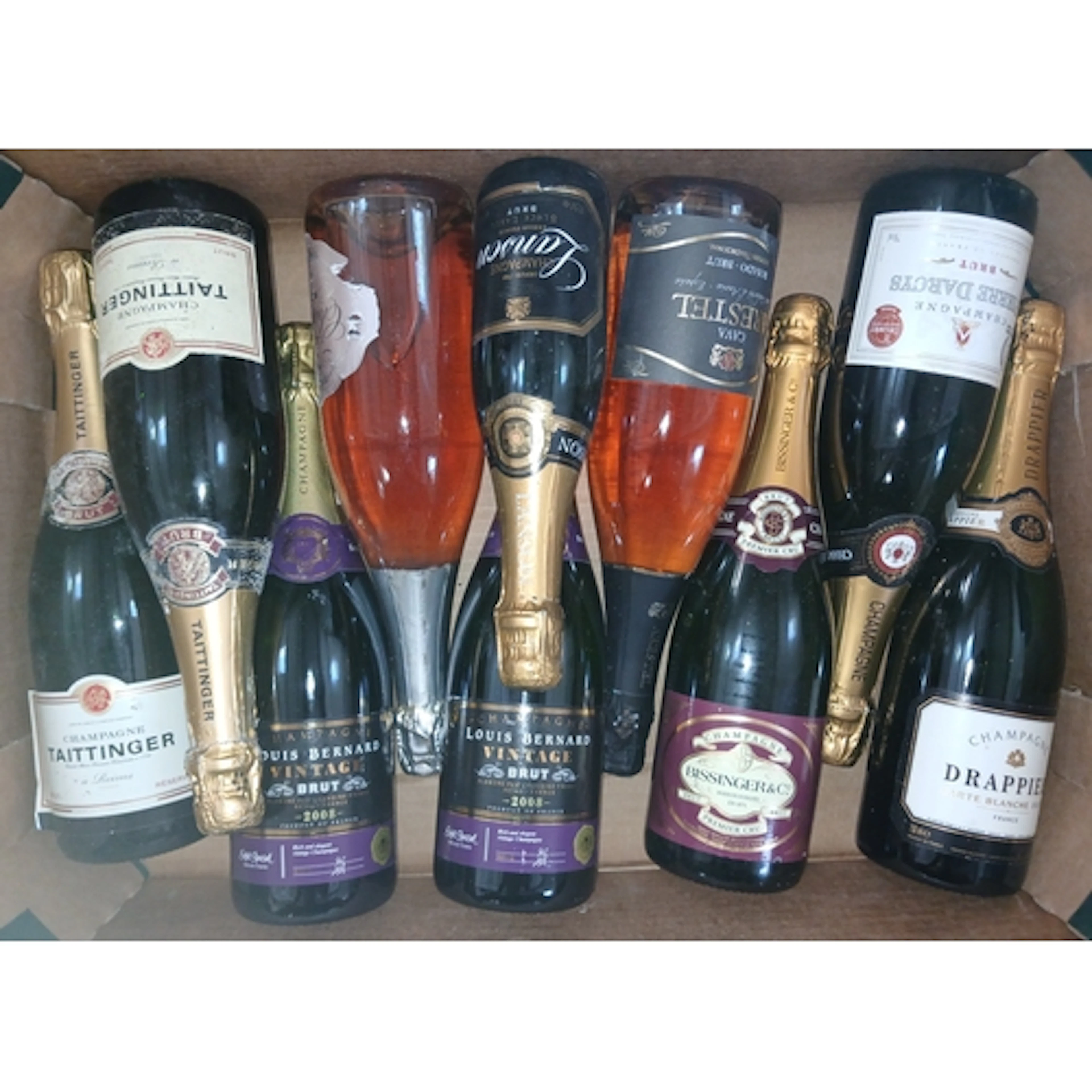 Nine bottles of assorted sparkling wine.