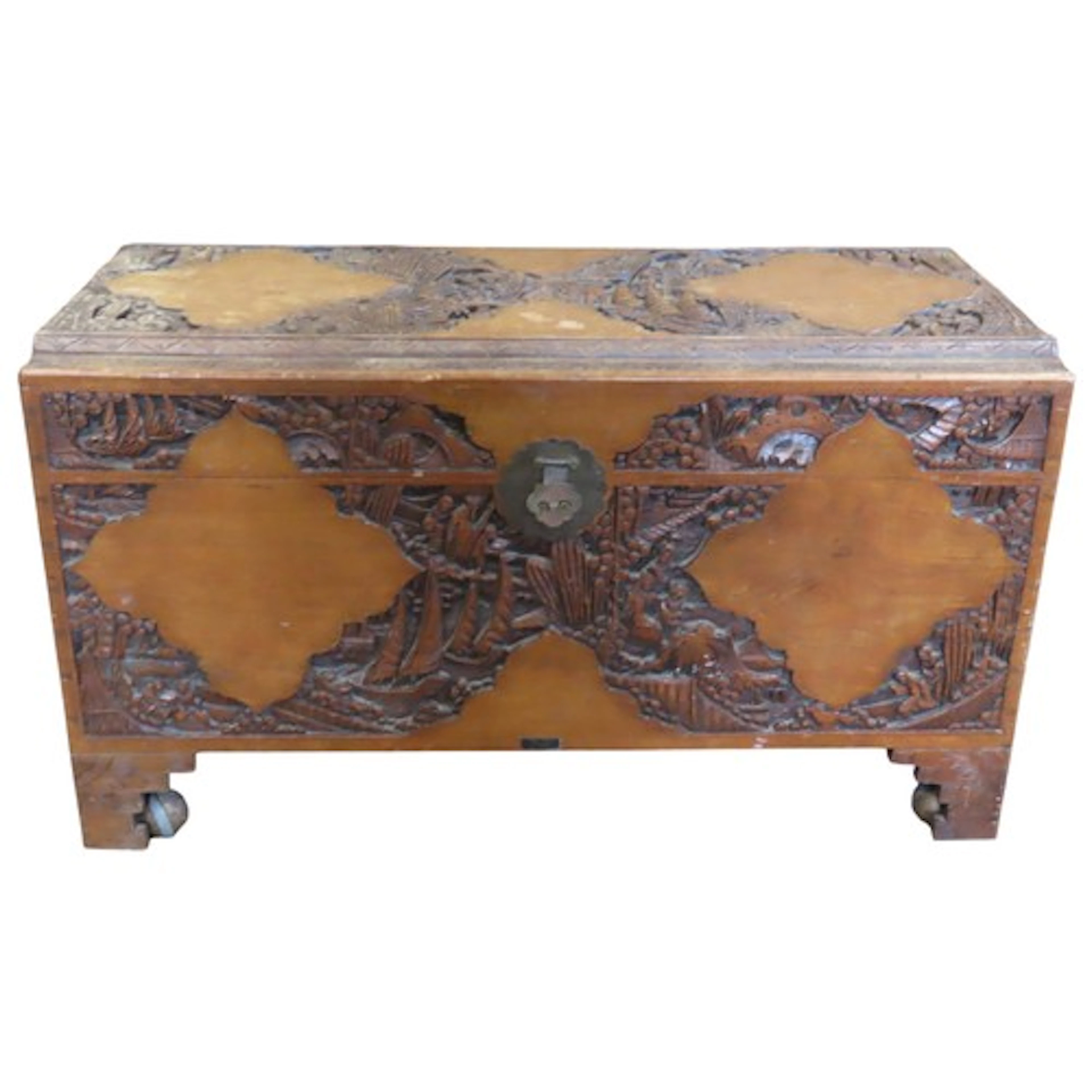 An Eastern camphor wood chest with hinged lid and carved det...