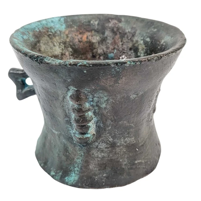 An antique Chinese bronze mortar bowl with flared rim, waist...