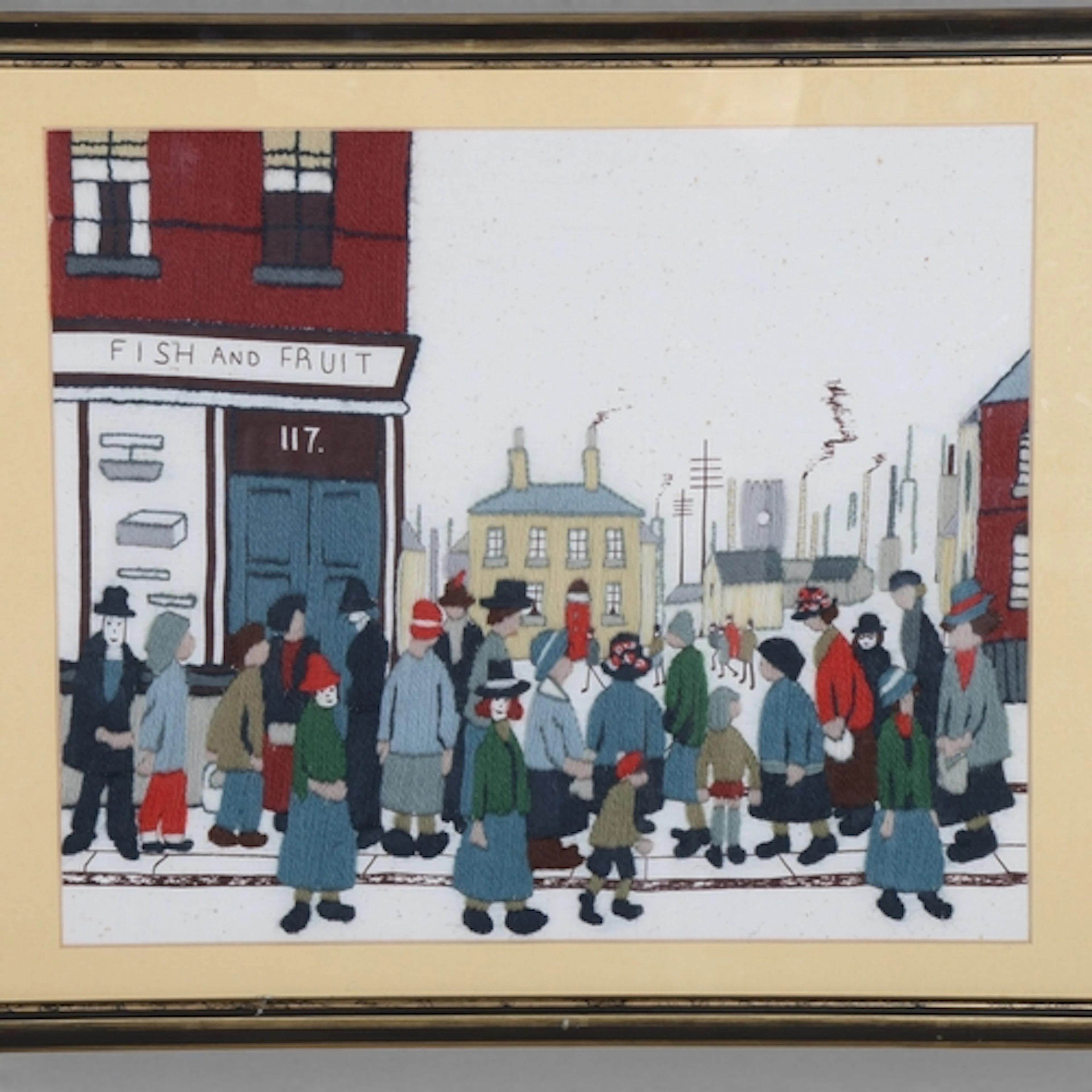 A woolwork tapestry street scene in the manner of LS Lowry, ...