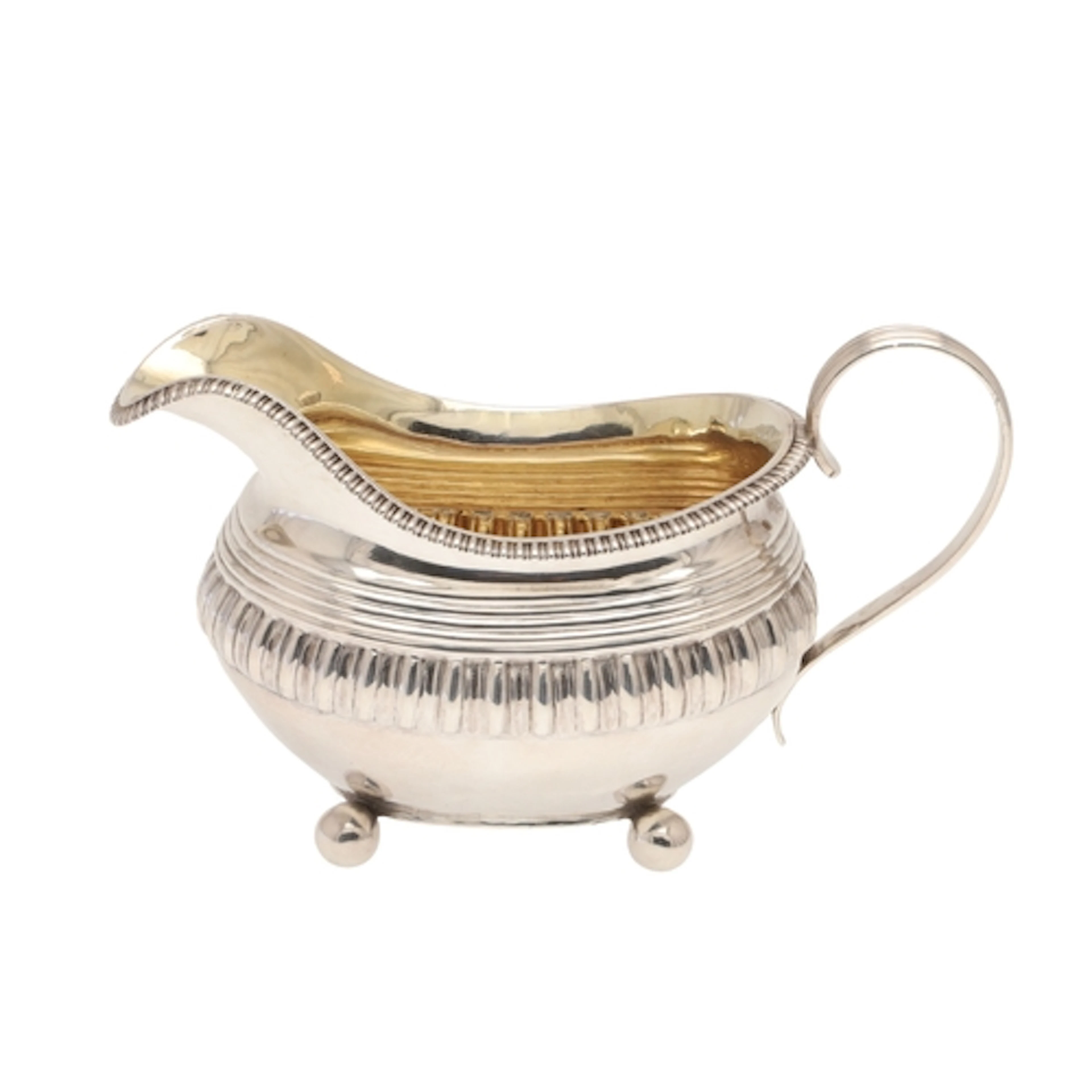 A LARGE GEORGE III SILVER CREAM JUG. With reeded handle and ...