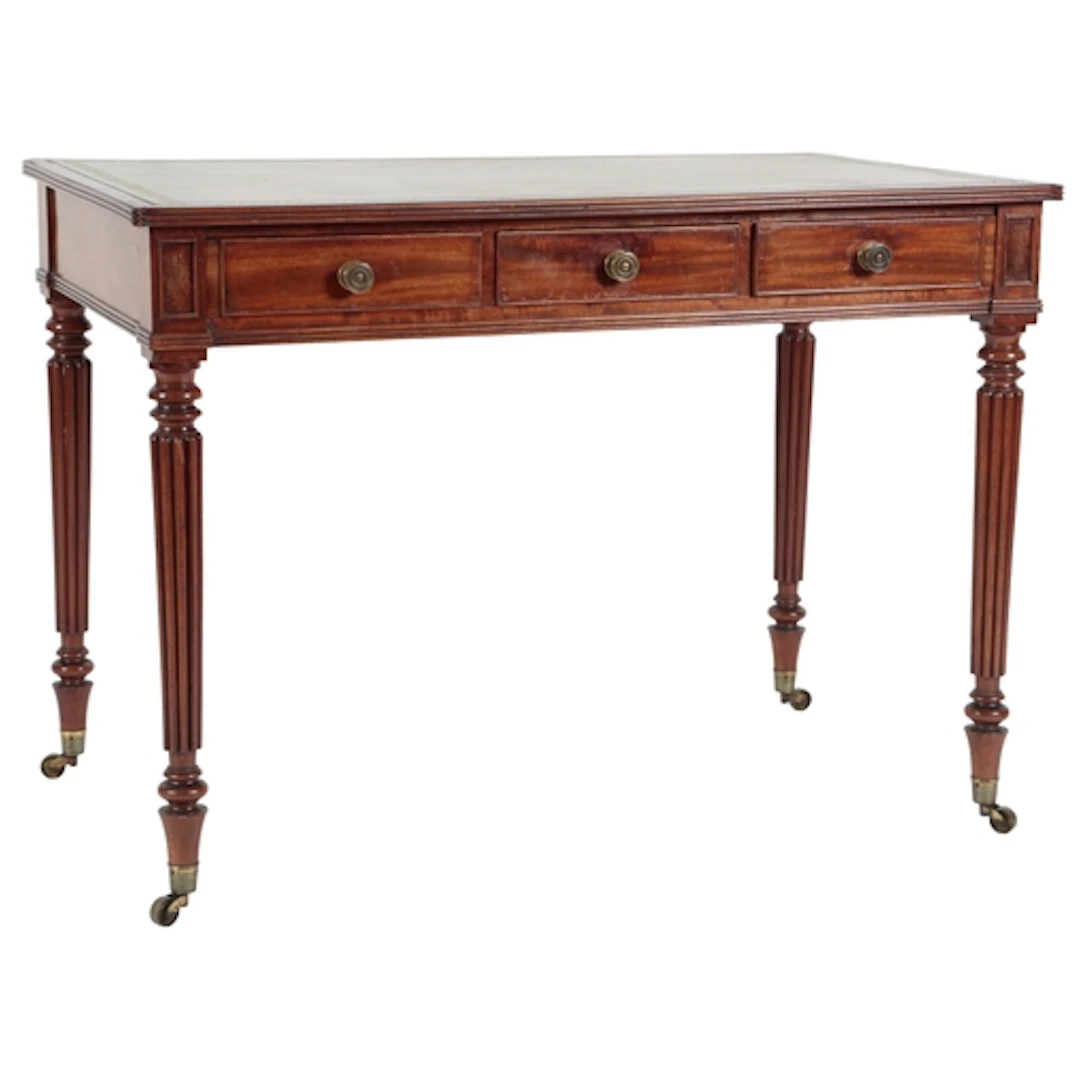 A George IV mahogany library table, with gilt tooled bottle ...