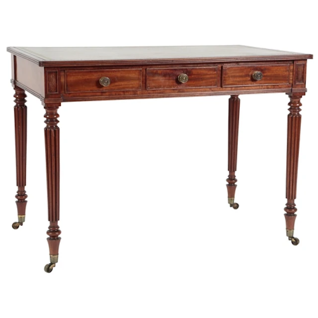 A George IV mahogany library table, with gilt tooled bottle ...