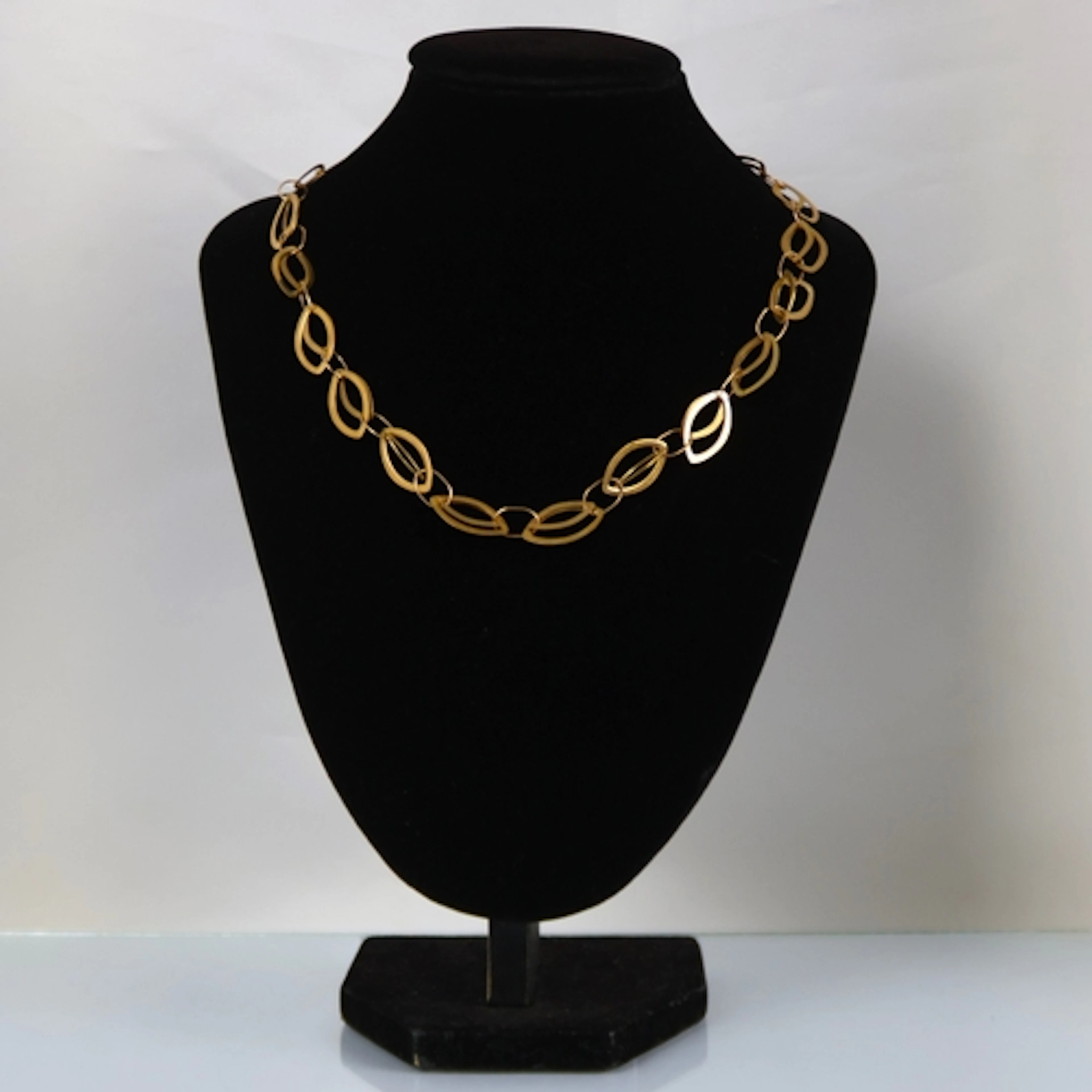 A contemporary yellow metal necklace, the shaped oval links ...