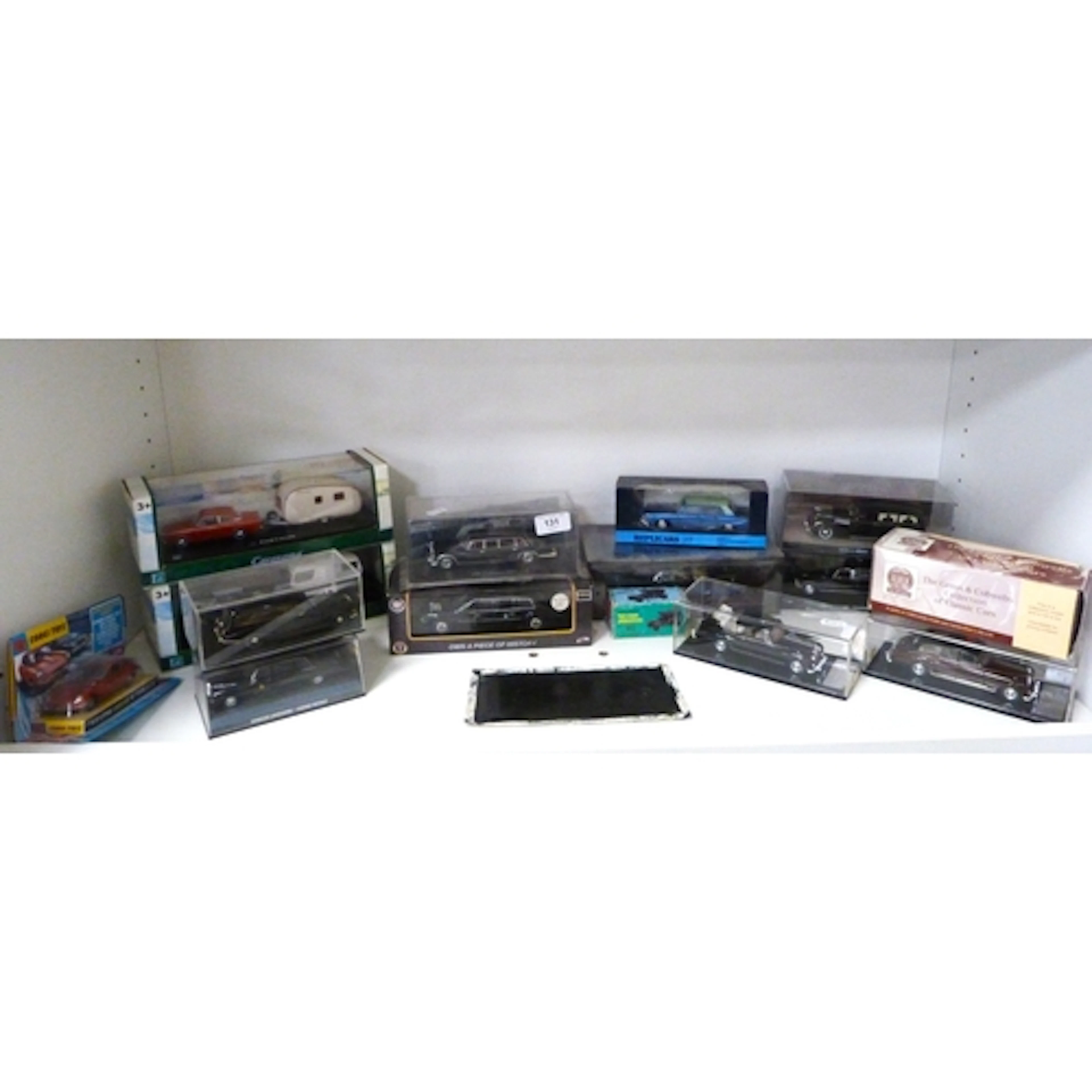 Shelf containing collectable model cars to include scale and...
