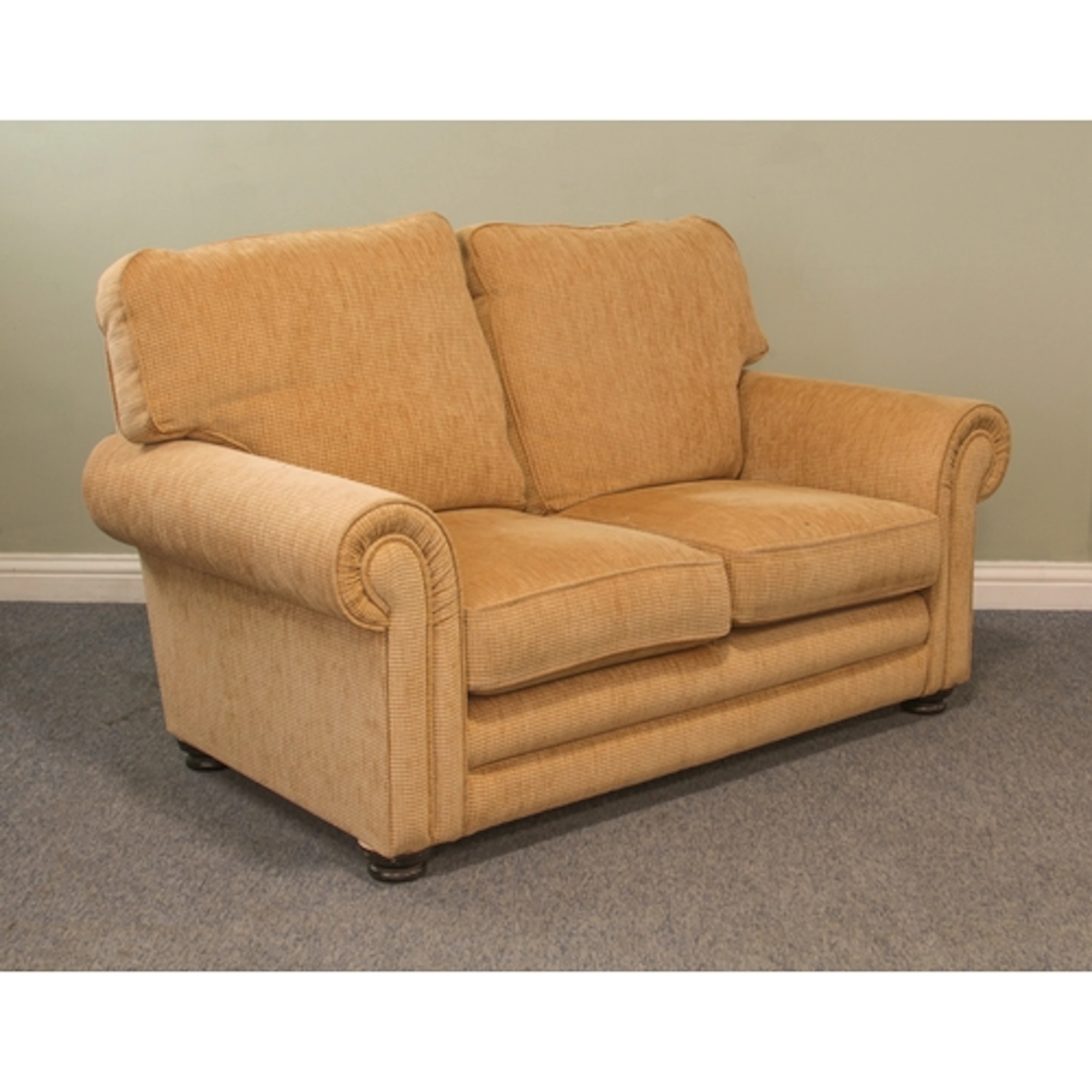 A modern two-seater sofa - upholstered in gold, on turned st...