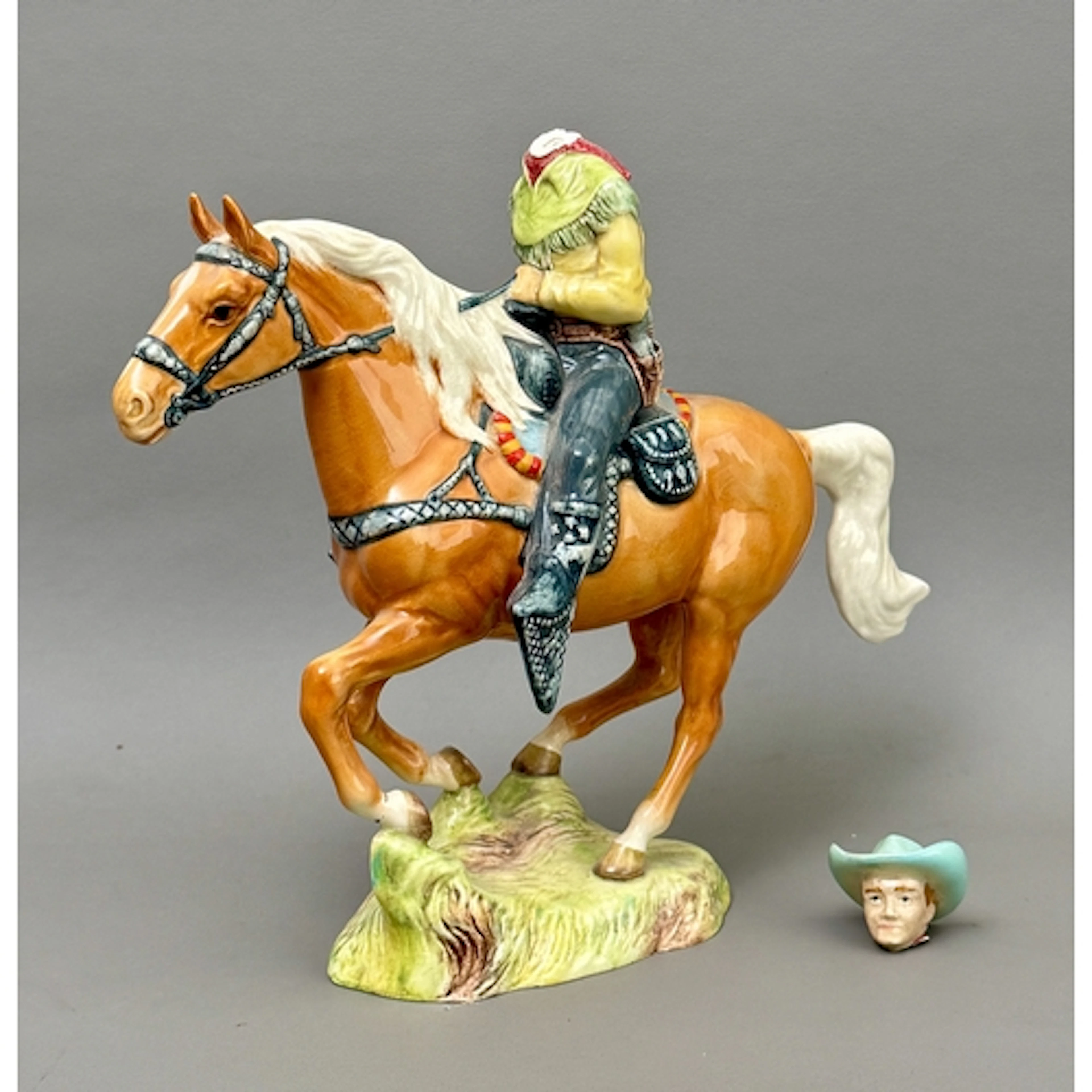 A Beswick figure of a Cowboy mounted on a palomino horse, mo...