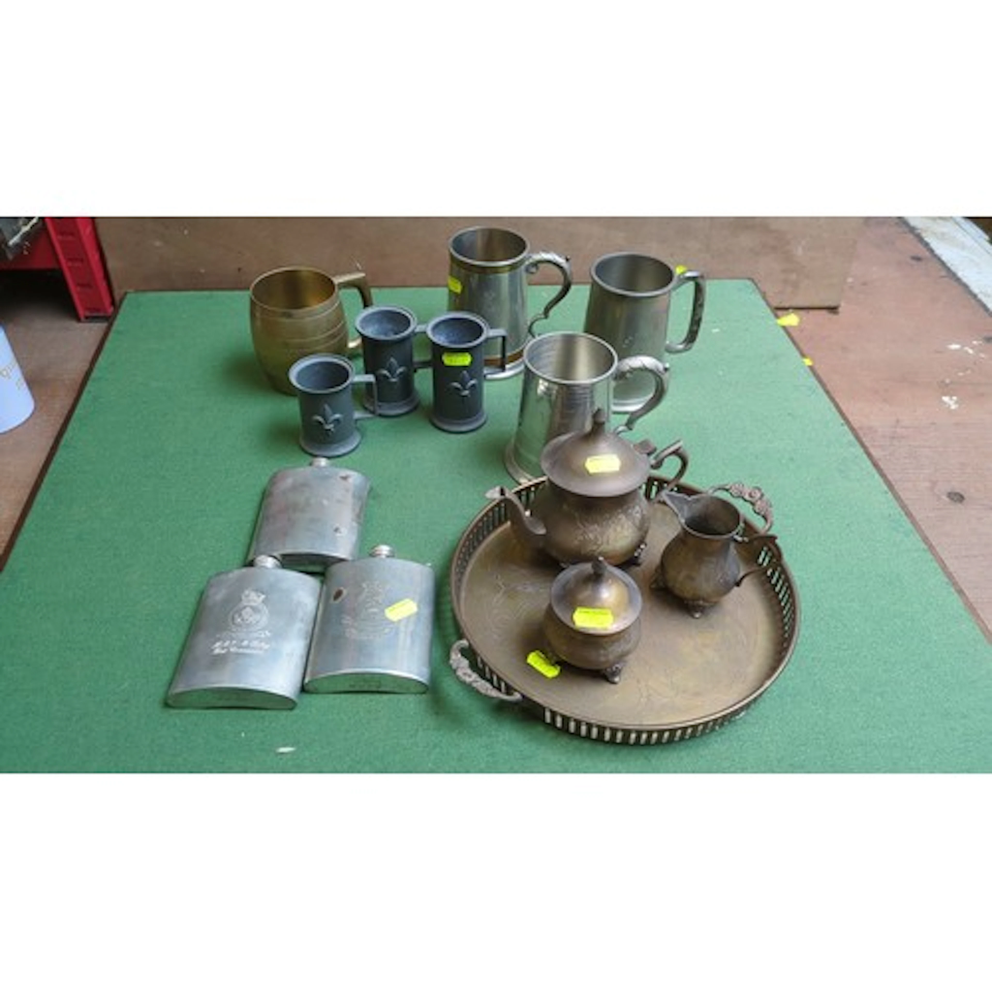 A mixed group of metal drinking and serving wares, including...
