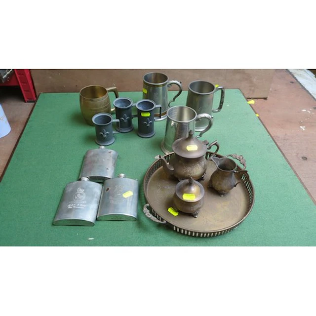 A mixed group of metal drinking and serving wares, including...