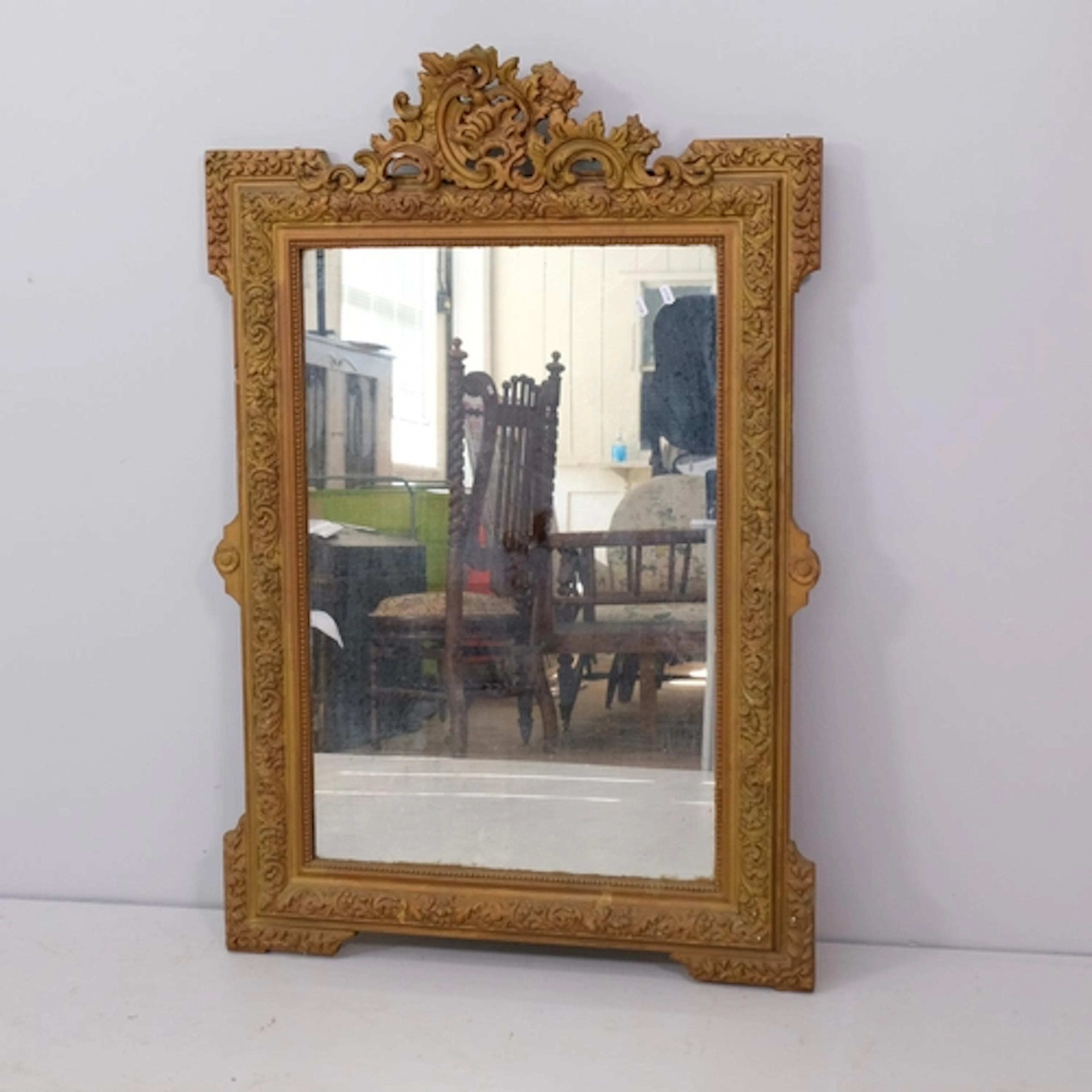 A large continental gilt framed wall mirror with rococo moul...