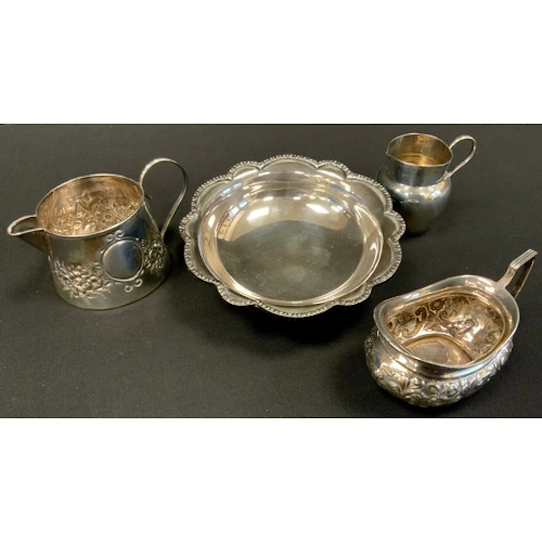 Silver - an Edwardian silver cream jug, embossed with floral...